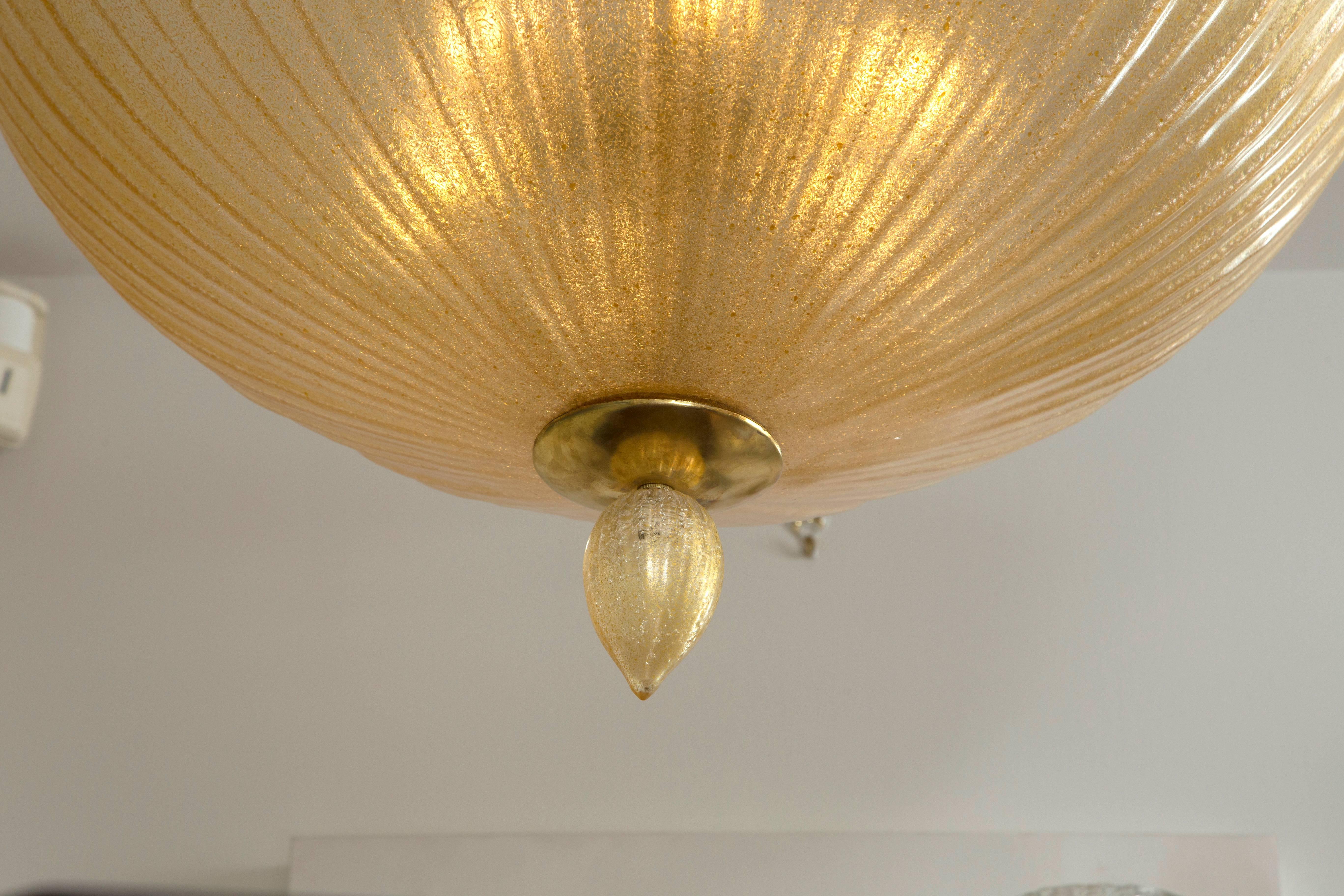 Blown in a soft gold toned color this lovely extra large dome shaped ceiling fixture with finial is illuminated with 5 medium base lights, non UL
please note weight of 36 lbs


Origin Italy
Period:  newly blown
Glass Dimensions of glass: 32”