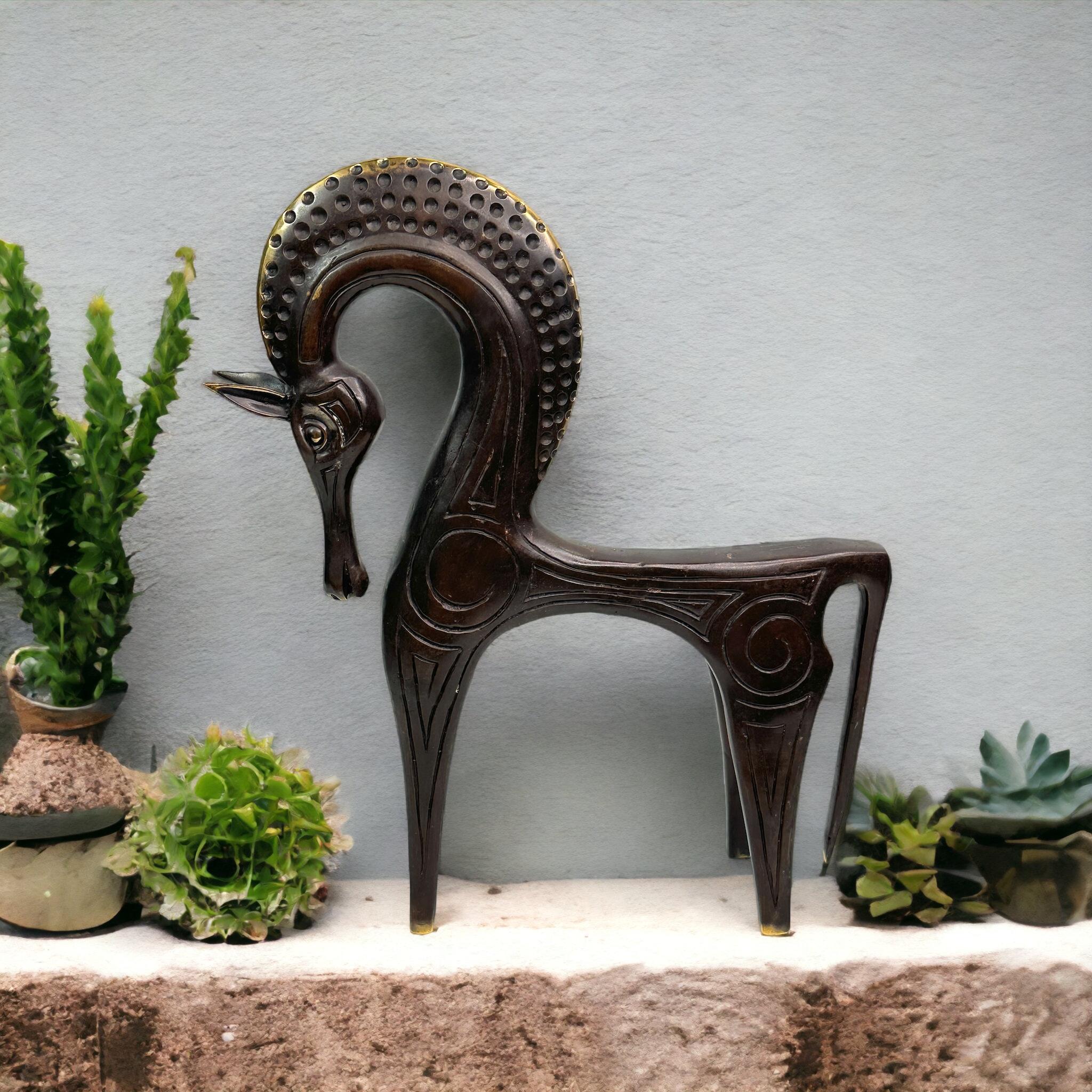 This is a bronze sculpture, in the style of the antique statues and figures of the Etruscans. It is a gorgeous interior furnishing item, an incredibly stylized Horse and has a patina finish. Greece-made and great for any Mid-Century Modern