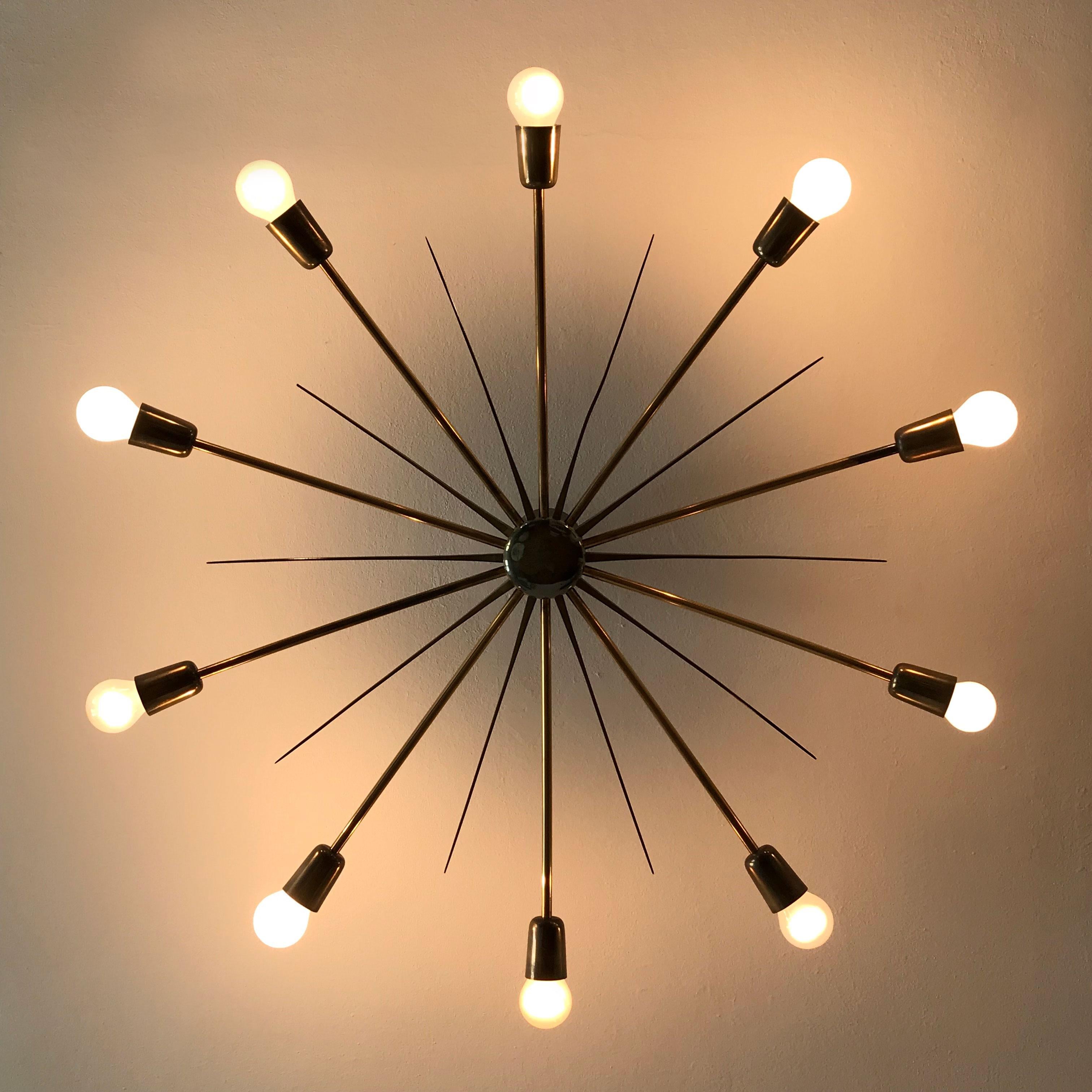 Gorgeous, gigantic Mid-Century Modern ten-armed Sputnik chandelier or ceiling lamp Sun Mod. 5160 with a diameter of ca. 39.37'' / 100 cm.
Manufactured by J.T. Kalmar, Vienna, Austria, 1950s. Executed in solid brass tubes and sheet.

The chandelier