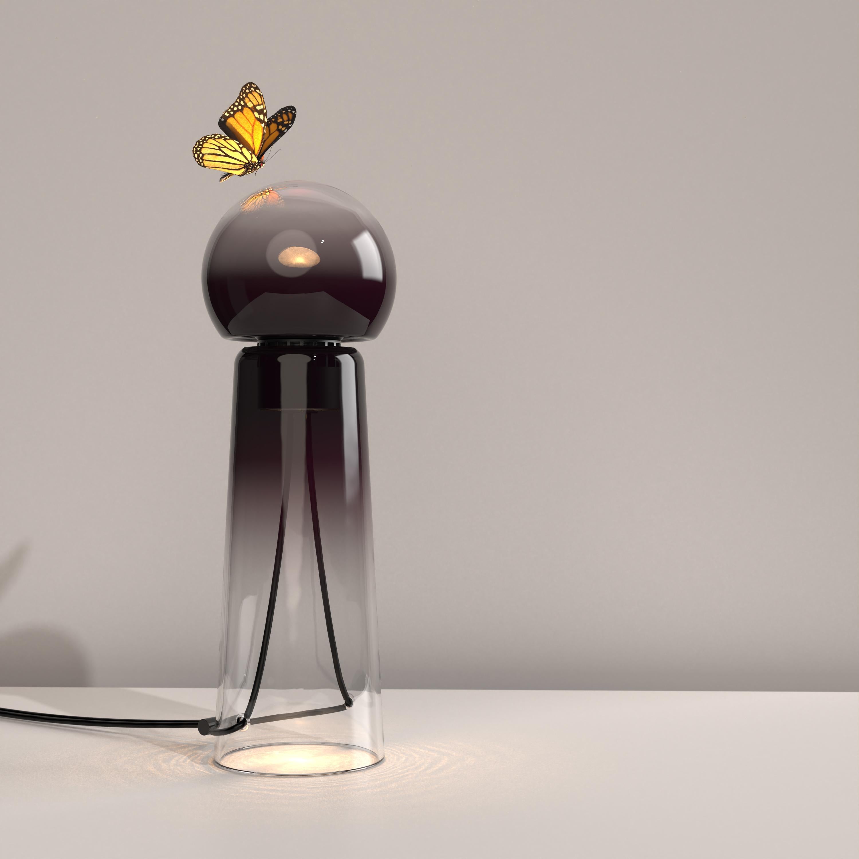 Gigi Dark (Dark Purple) is a contemporary LED table lamp made of handcrafted blown glass.

Gigi is playful. Its lines are daring and its tones sensual. Under the breath of the glassblower, the unique shades and tones of the colour spread