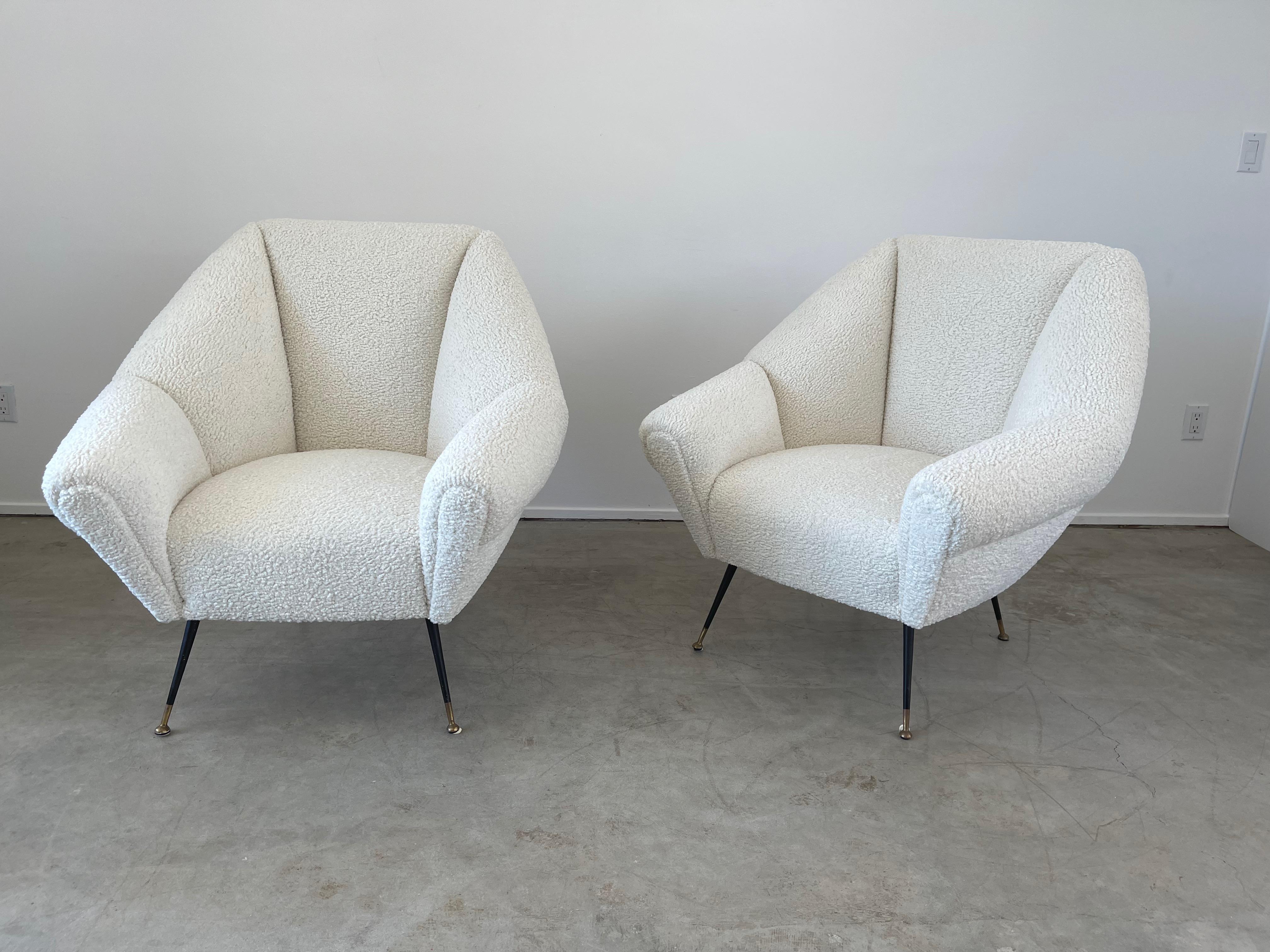Wonderful pair of newly upholstered Italian chairs attributed to Gigi Radice 
Great sculptural shape and large in scale
Iron and brass legs - new shearling -like boucle upholstery.