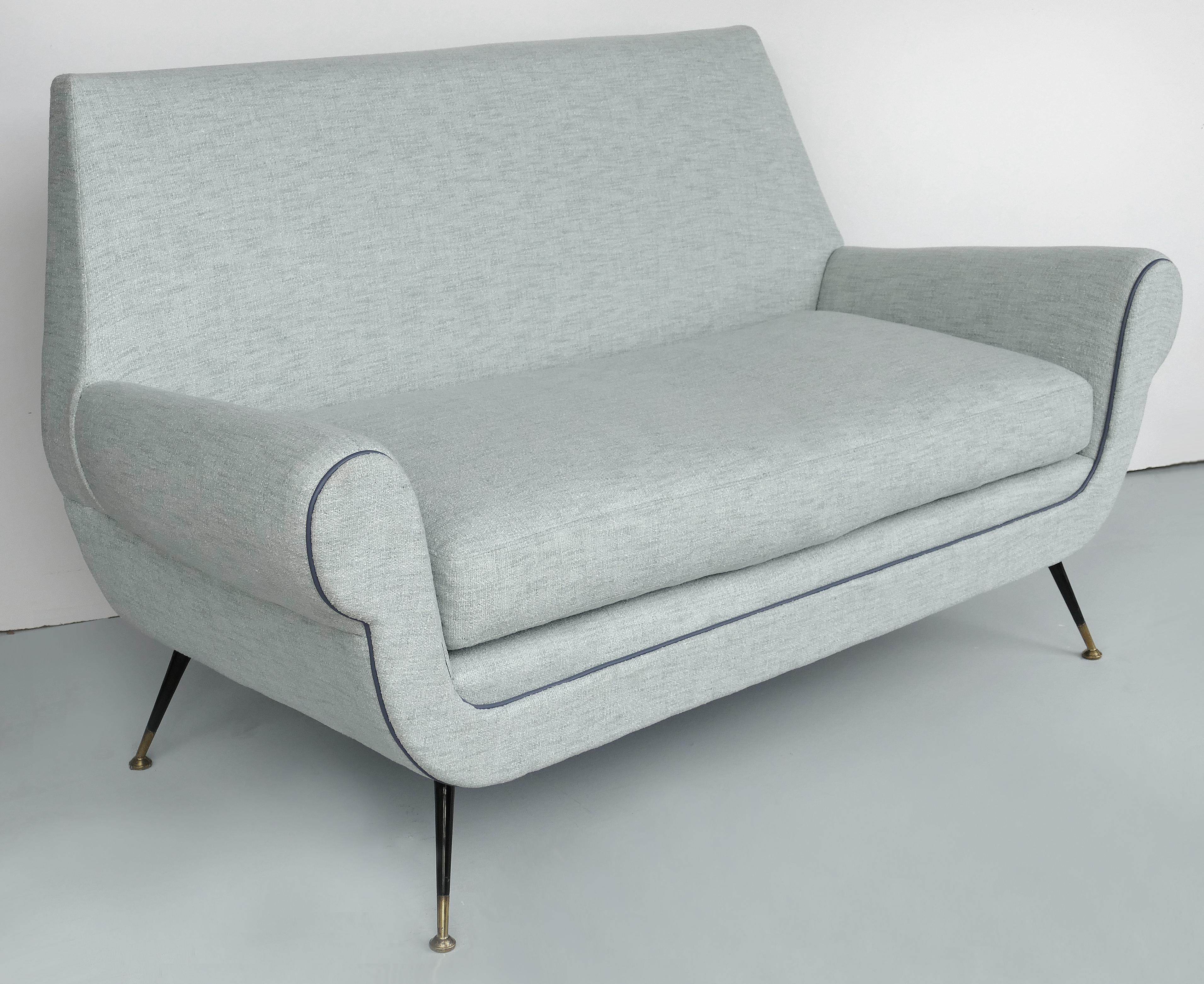 Gigi Radice for Minotti Italian modern settee sofa, circa 1950.

Offered for sale is a newly upholstered Italian Modern settee sofa by Gigi Radice for Minotti. The circa 1950s two-seat sofa has tapered and splayed iron and bronze legs. The