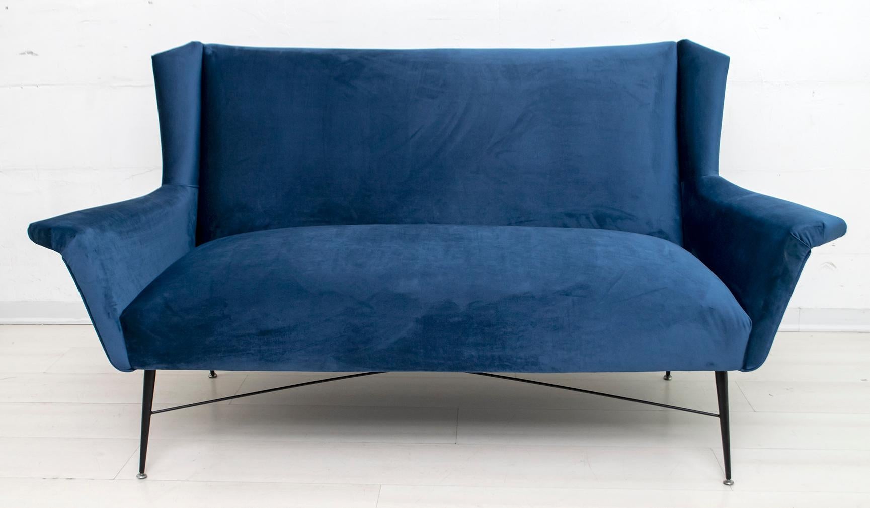 Sofa designed by Gigi Radice for Minotti. Made with solid wood structure and blue velvet upholstery and black lacquered metal legs. The upholstery has been redone.