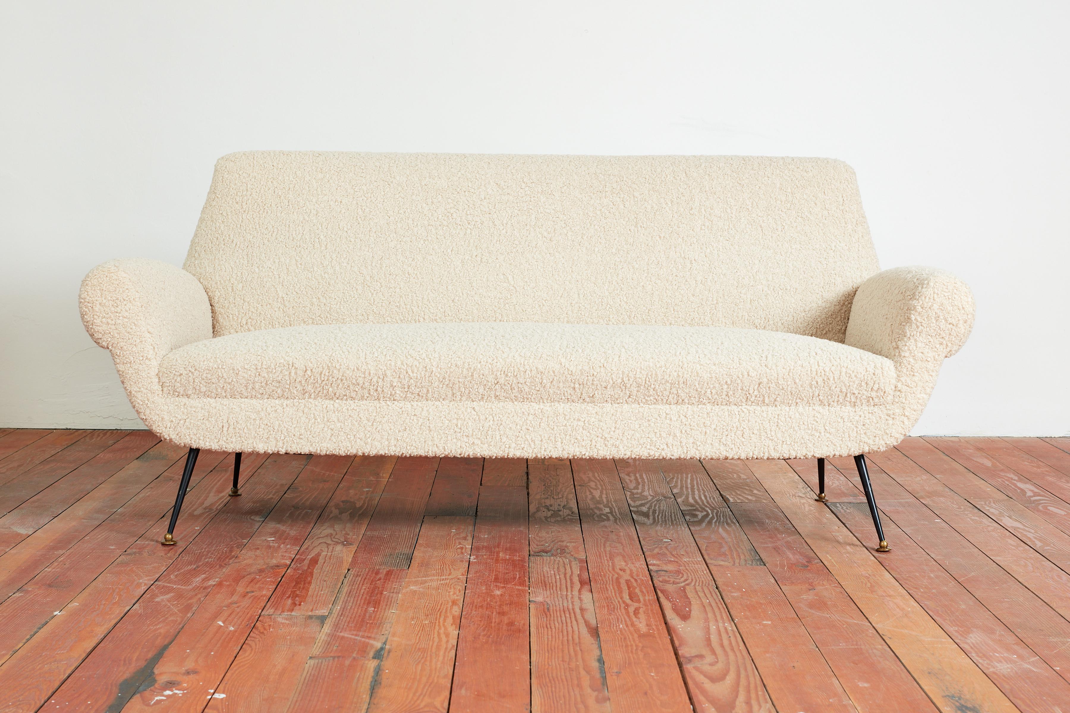 Gigi Radice sofa settee for Minotti - Italy, 1950's
Reupholstered in creamy wool boucle with iron splayed legs with brass feet.
Great curved shape with clean lines.
Matching pair of armchairs available.