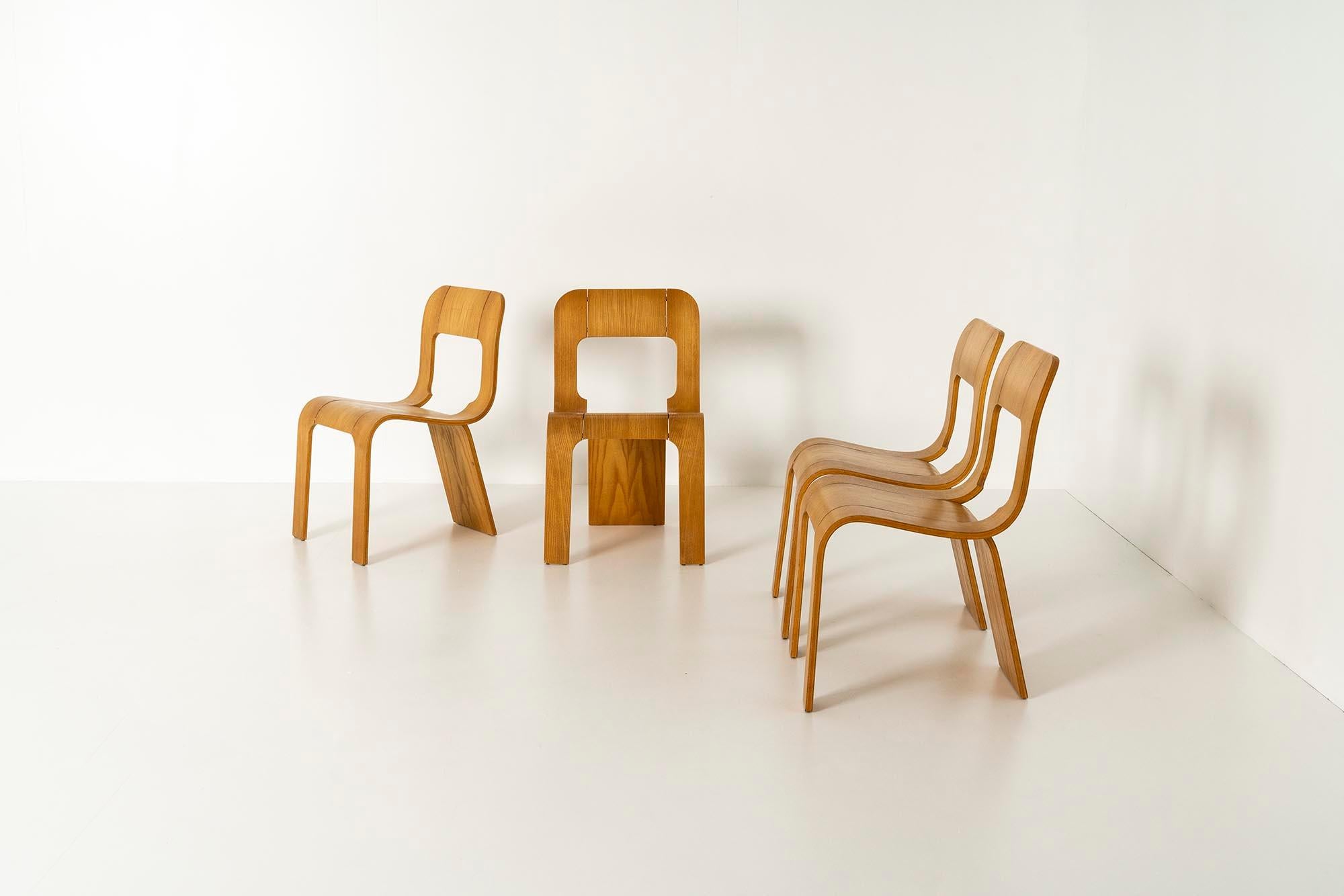 Gigi Sabadin, set of four stackable chairs 'Model S' for Stilwood, Italy ca 1973. These vintage Italian chairs are made of bent plywood with ash veneer and finish. The design has organic shapes and three legs. The backrest has an opening. These