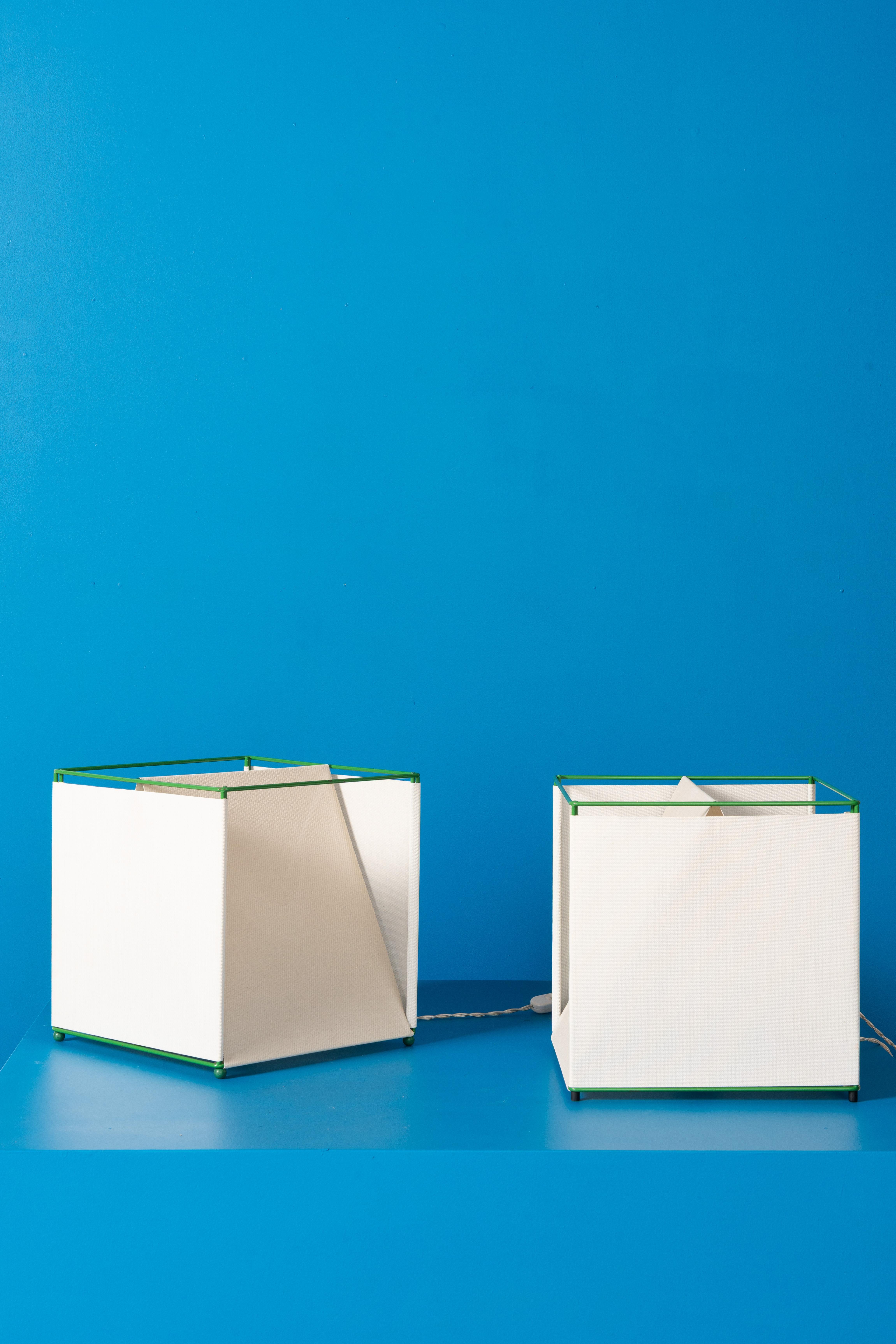 Sculptural table lamp designed by Piero De Longhi for IBIS around 1975. Features a lacquered metal base and an opaline glass diffuser. Presented in green, and carefully restored by our artisans in Brussels.