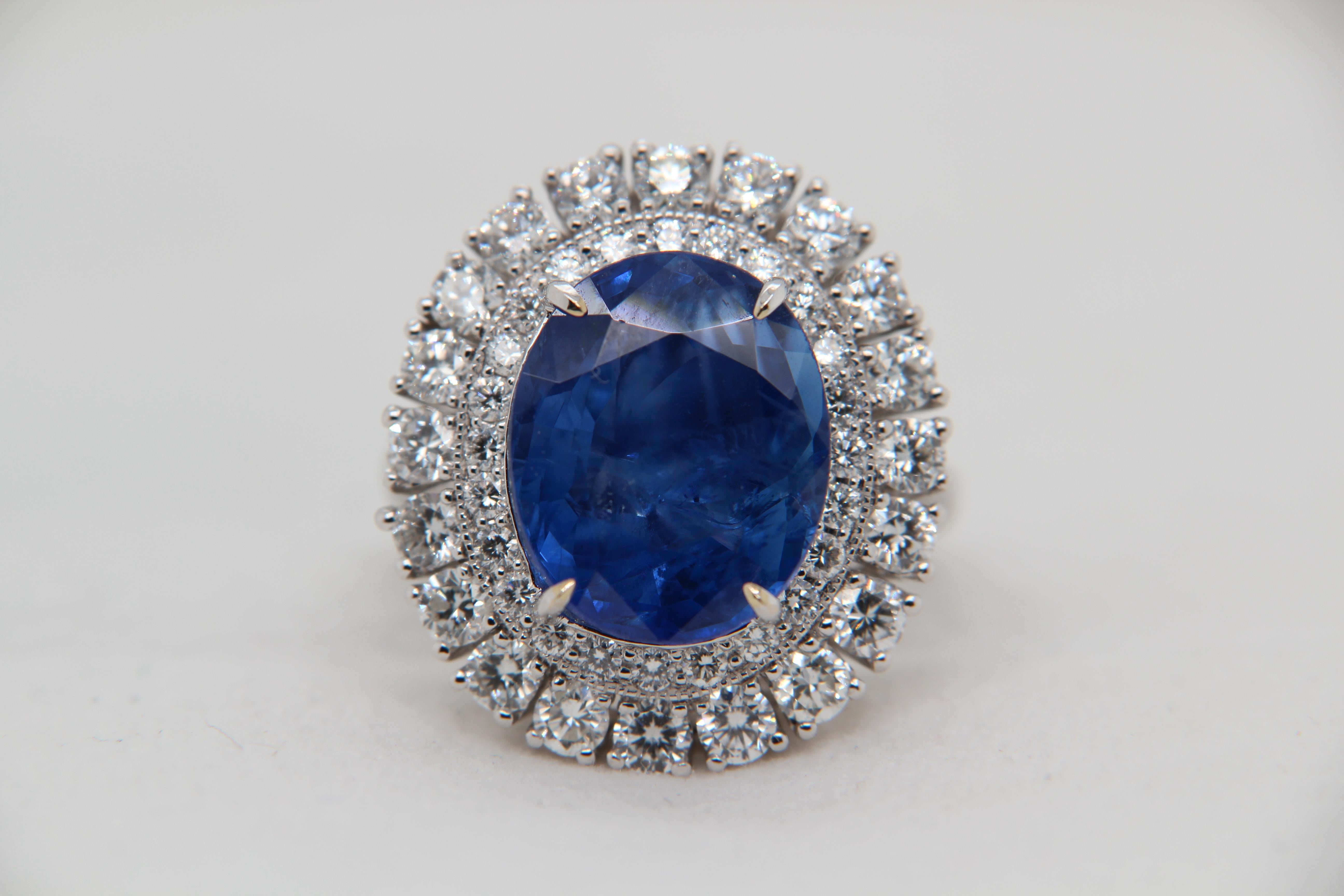 A blue sapphire and diamond ring. The ring's center stone is 9.66 carat Burmese Blue Sapphire certified by Gemological Institute of India (GII). The center stone is surrounded by 2.05 carat round shaped diamonds and mounted on 18K white gold gross