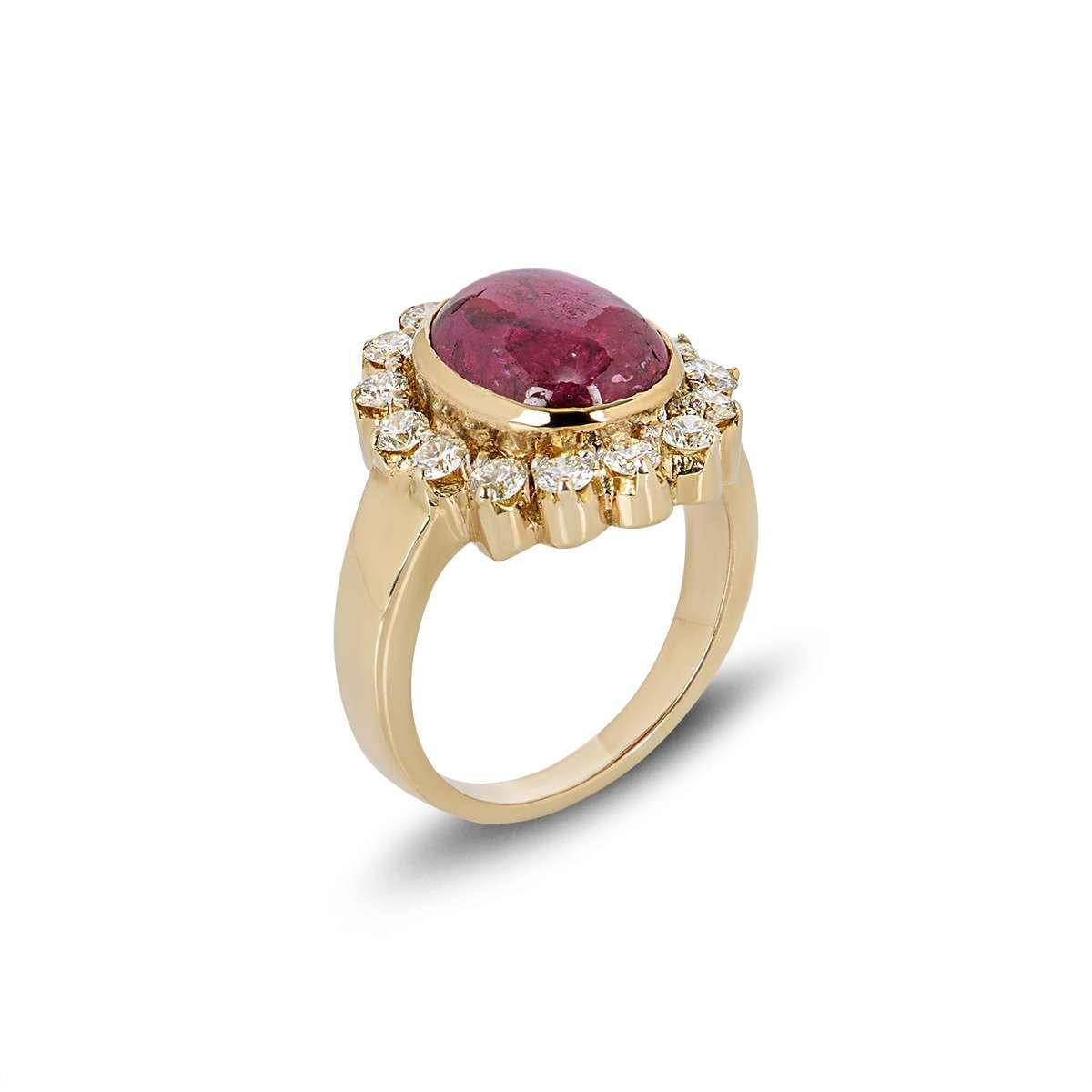 A beautiful 18k yellow gold diamond and natural ruby cluster ring. The ring is set to the centre with an oval ruby in a rubover setting weighing 5.03ct. Accentuating the central stone are 15 round brilliant cut diamonds in a cluster setting with a