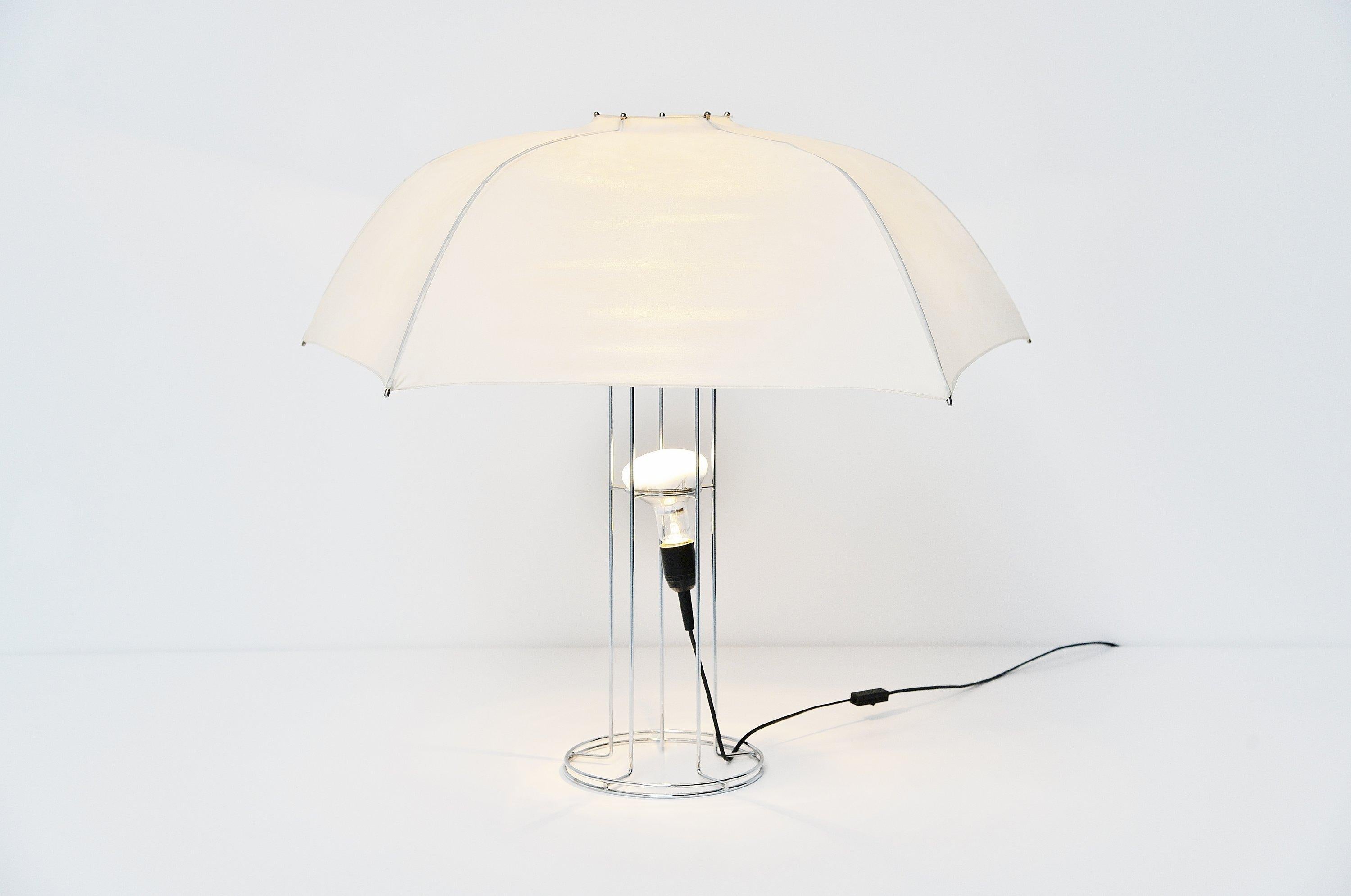 Cool umbrella table lamp designed by Gijs Bakker and manufactured by Artimeta, Holland, 1973. Bakker was inspired by the type of lamp that photographers use. The five ribs continue as the five rods of the stand. The reflecting lamp is suspended in