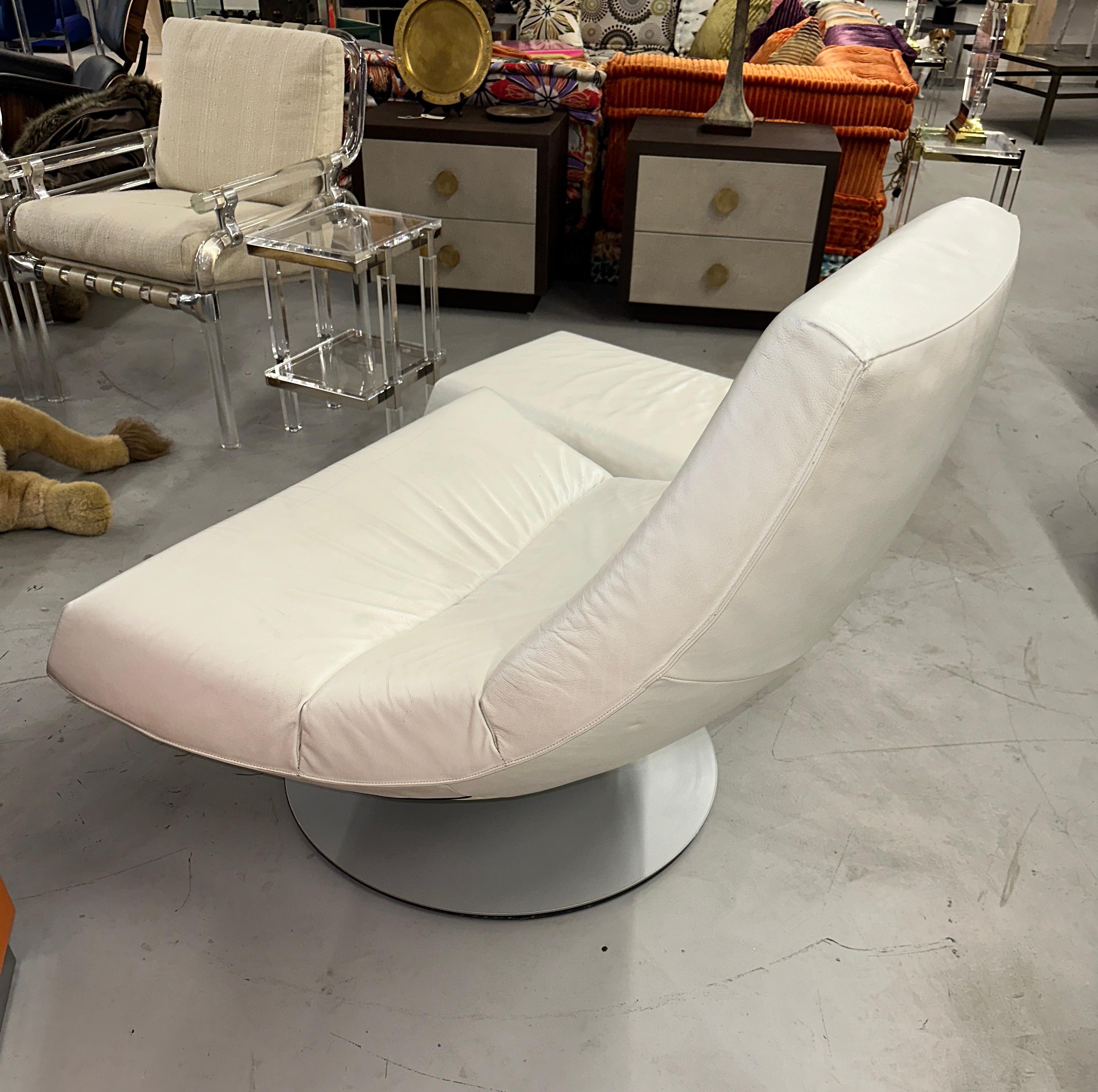 Olivier swivel easy chair and ottoman in white leather. The set is designed by Gijs Papovoine and was made by Dutch manufacturer Montis. Very comfortable and functional, both pieces rotate a full 360 degrees. Pictured next to a Herman Miller Eames