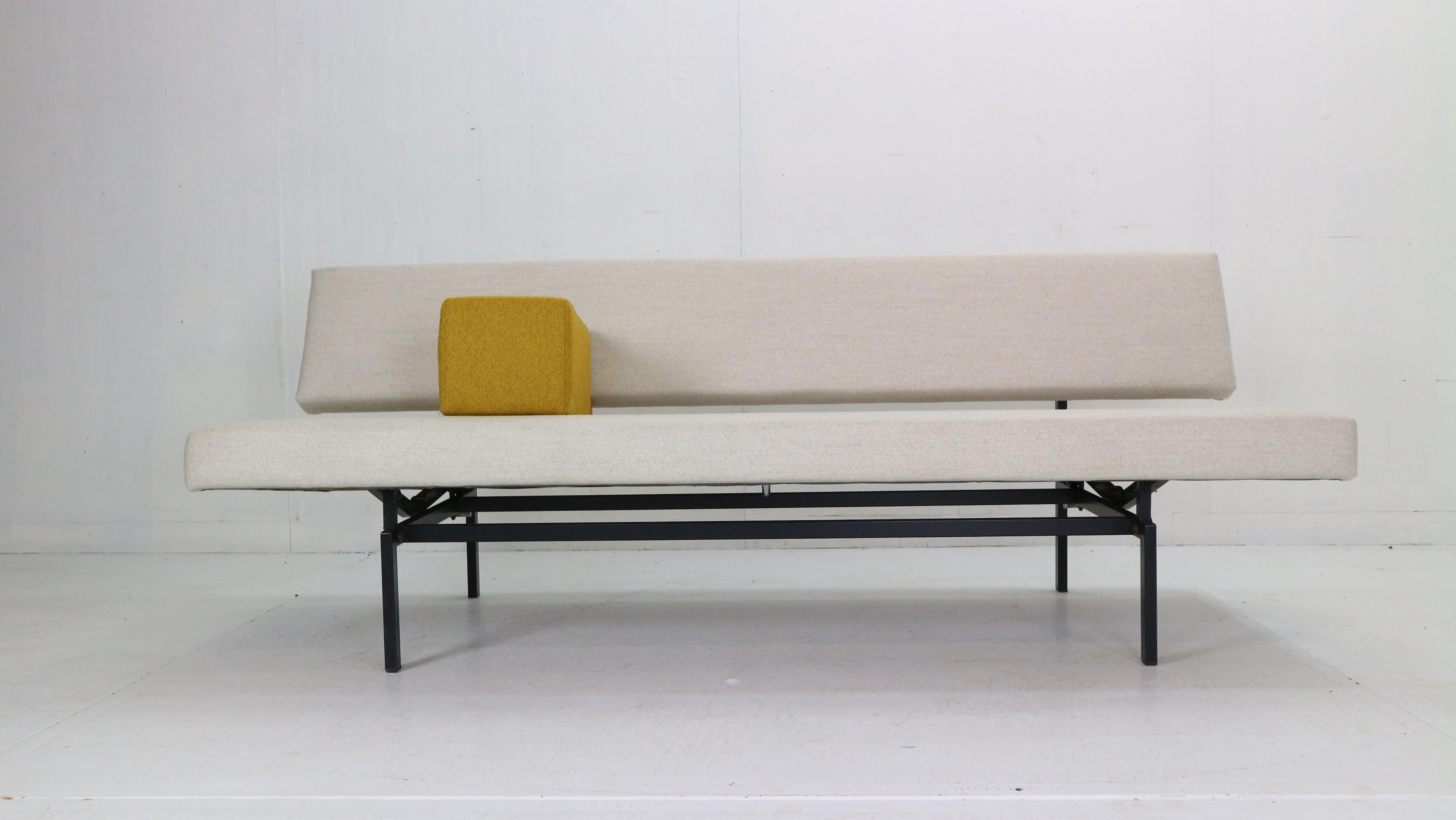 Minimalistic midcentury design sofa-daybed designed by Gijs Van Der Sluis, 1961s, Netherlands.
Model- 540.
Metal black frame and new upholstery in broken white wool fabric and yellow armrest.
The bottom pulls away from seat back to level out and
