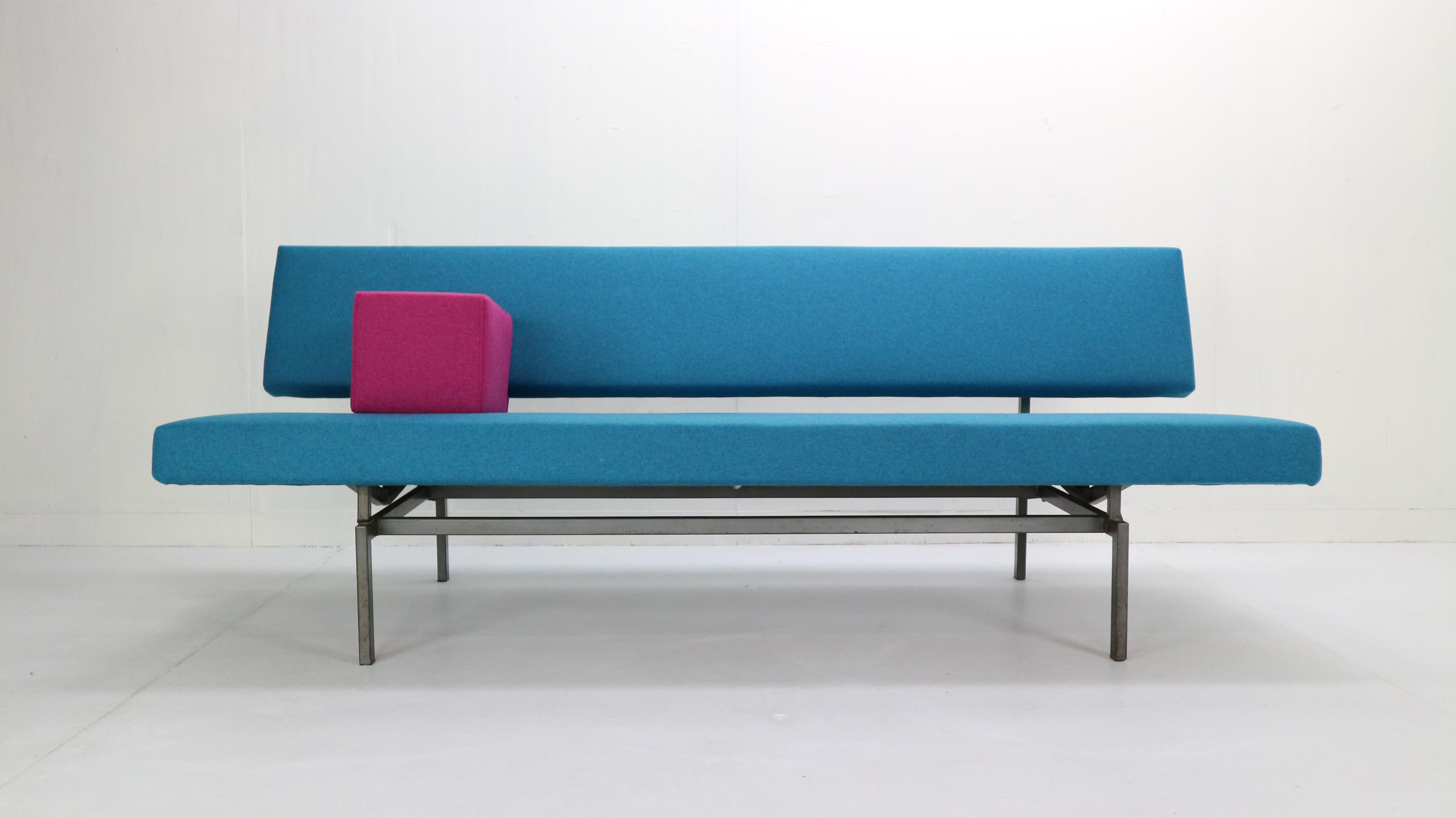 Minimalistic midcentury design sleeper sofa-daybed designed by Gijs Van Der Sluis, 1961s, Netherlands.
Model- 540.
Metal grey frame and new upholstery in blue fabric with pink armrest.
The bottom pulls away from seat back to level out and it