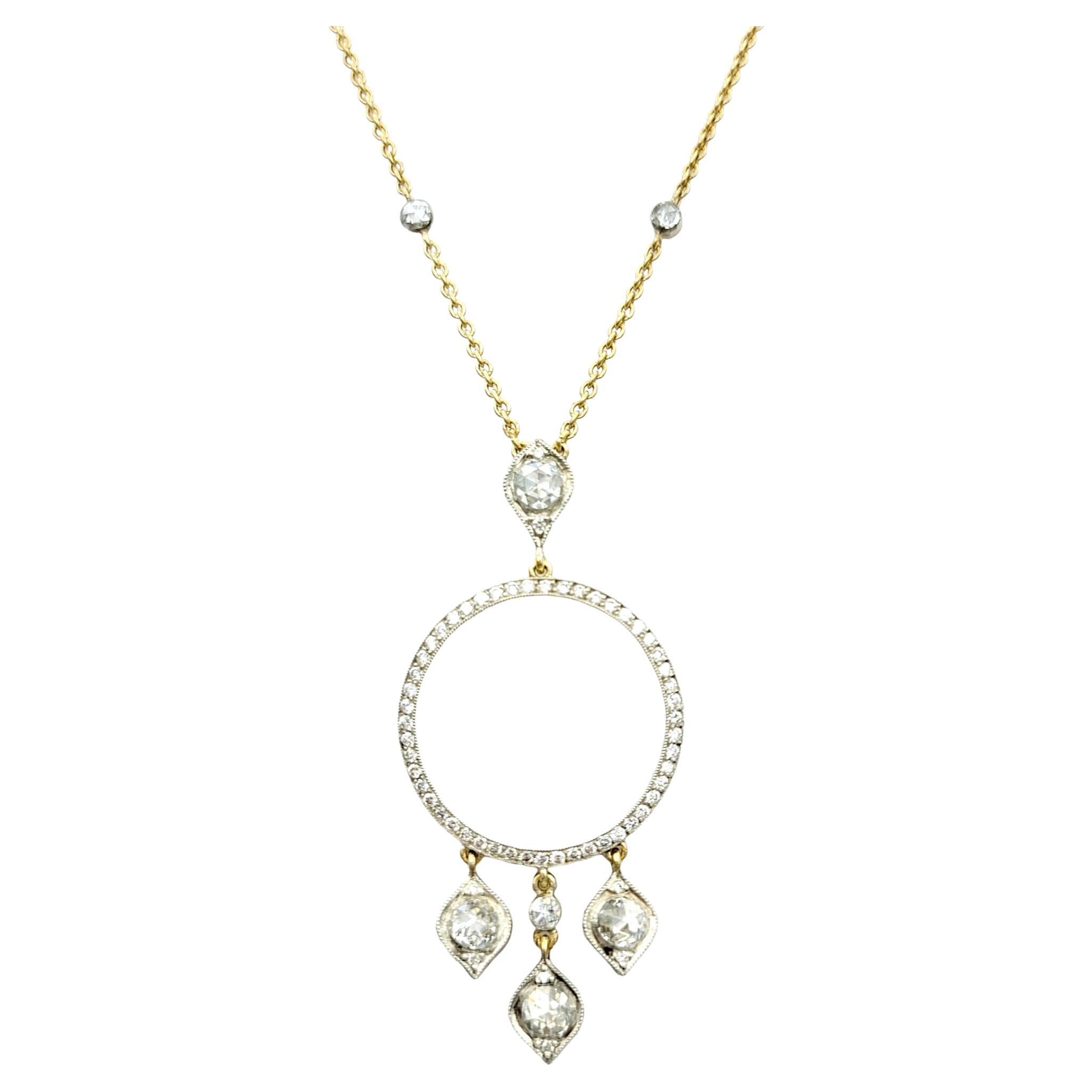 This captivating necklace, created by Gilan, is set in exquisite 14 karat yellow gold and is a beautiful embodiment of elegance and luxury. Its centerpiece is a stationary pendant showcasing a large open circle, encrusted with a mesmerizing array of