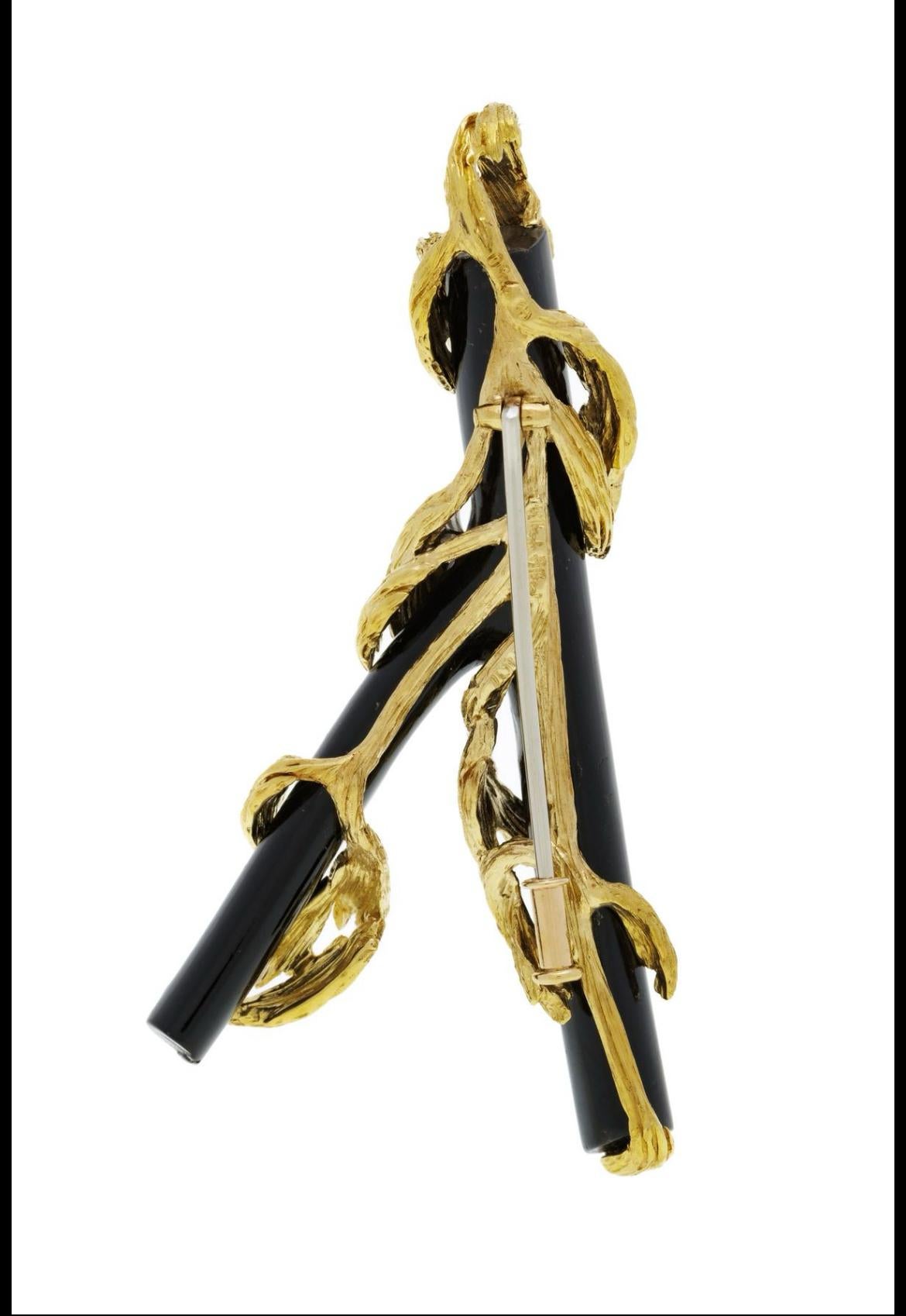 Black Coral and Diamonds turned into a mini sculpture to wear. Set on 18K Gold by Gilbert Albert in the 70s, this organic and precious piece is unique and collectible. You can wear it as a brooch or as a pendant.