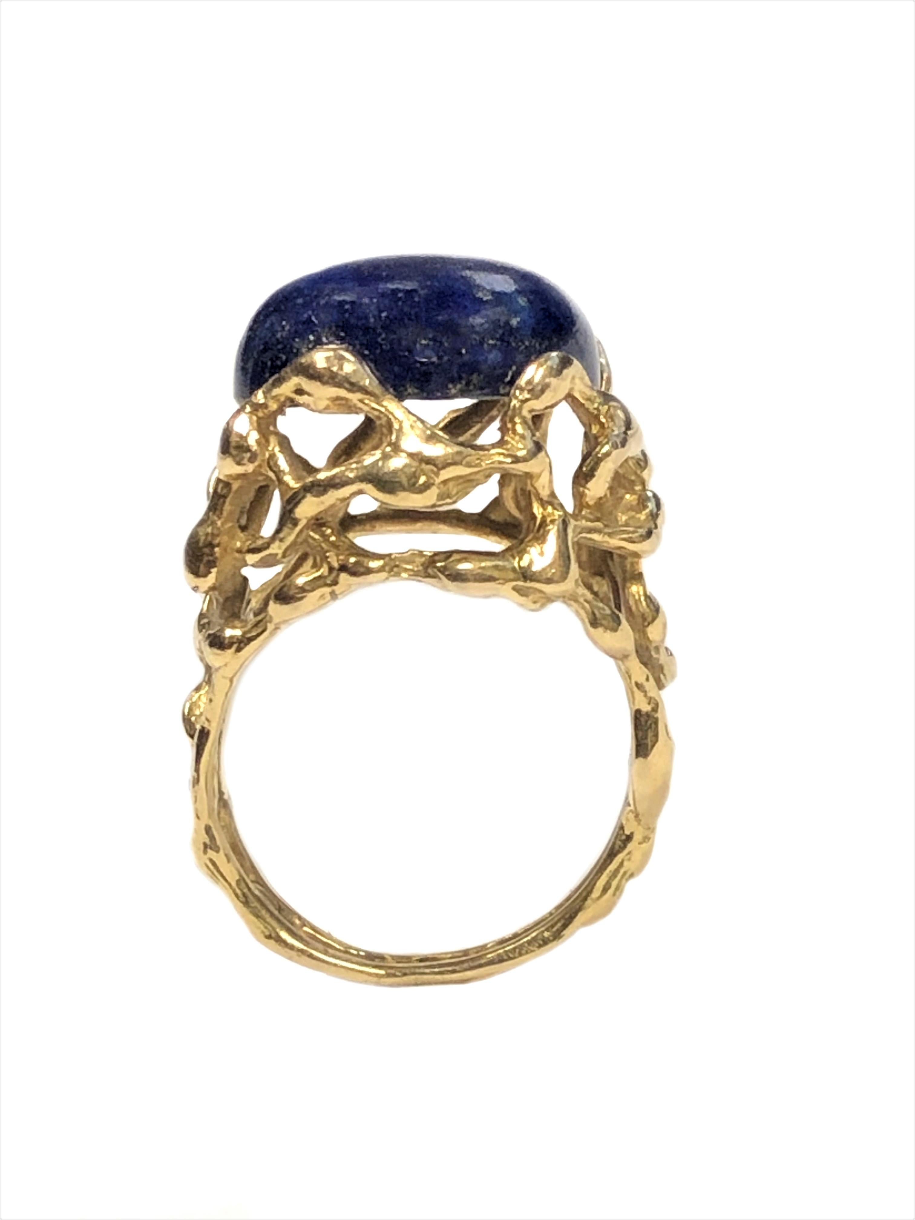 Circa 1970 Modernist Designed 18K Yellow Gold Ring by Gilbert Albert, centrally set with a Lapis Lazuli, the top of the ring measures 5/8 inch in diameter, finger size 6. 