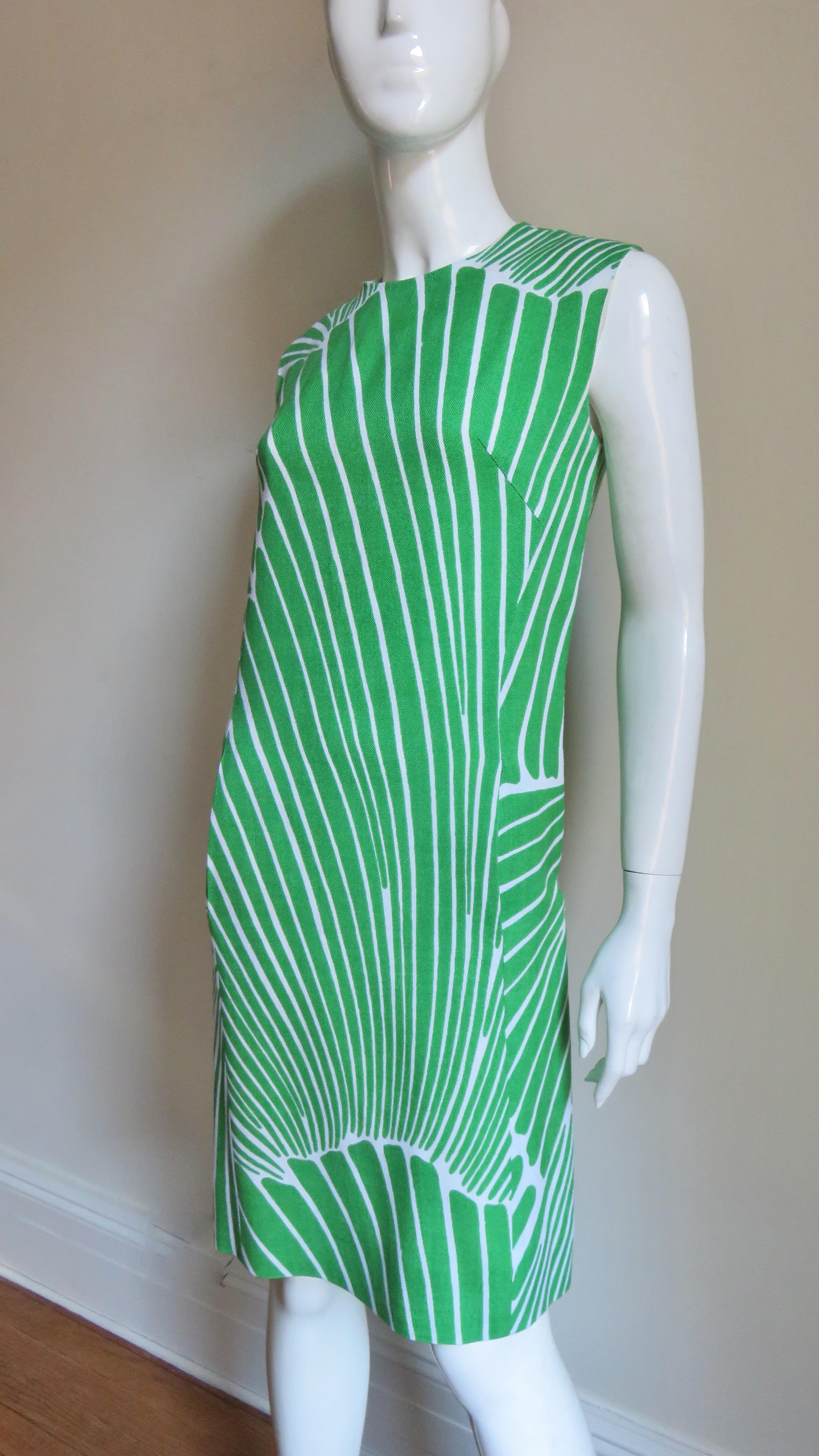 A fabulous geometric pattern linen dress and coat set in green and white by Gilbert Couture sold from Woldenberg's high end fashion shop of the time. The sleeveless shift dress has a crew neck and hip seam pockets.  The coat has a small lapel