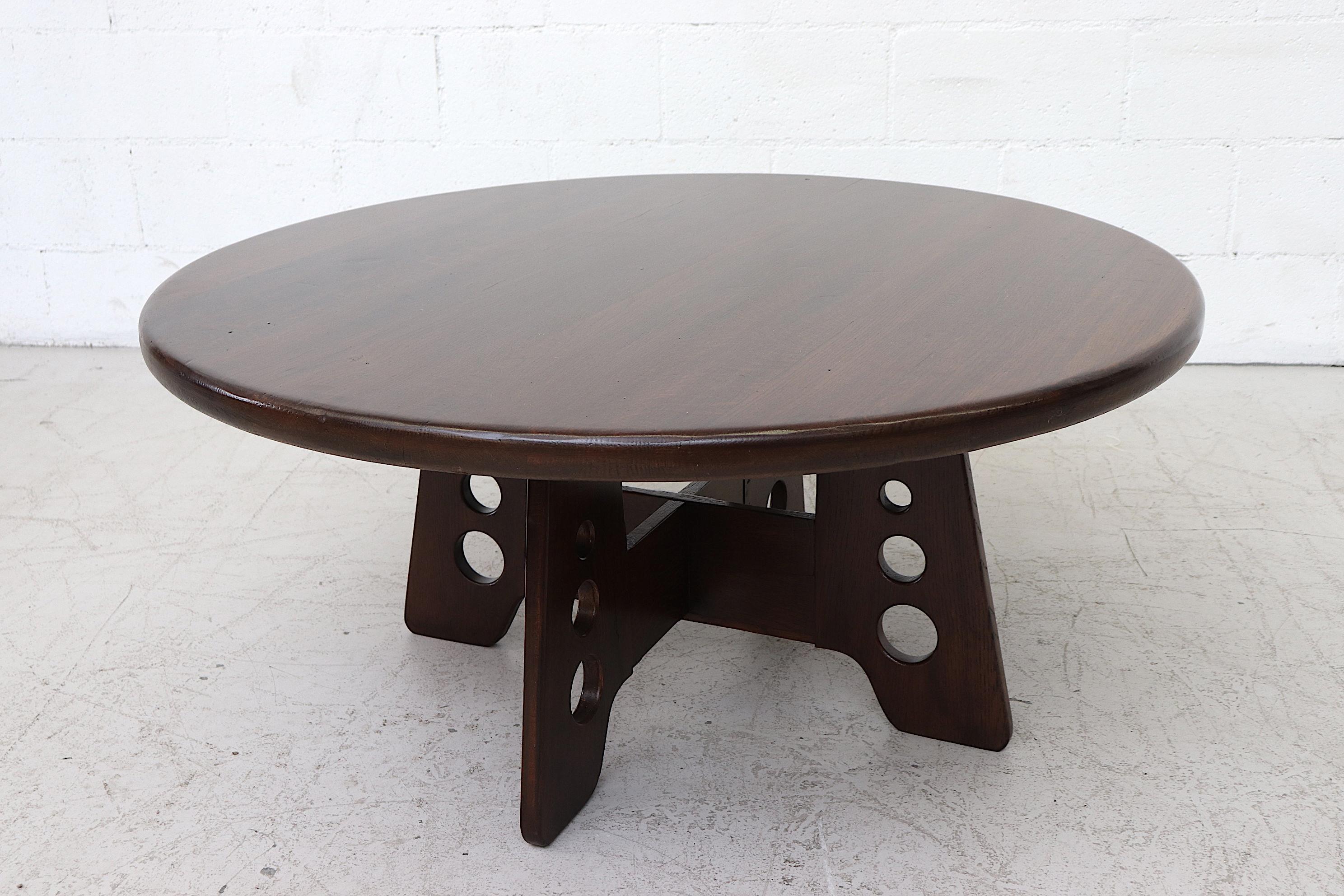 Round dark stained oak Gilbert Marklund (attribute) Brutalist coffee table. Lightly refinished with round cut-outs in matching wood legs. In original condition with wear attributed to age and use. Another light oak table available (LU922415583492)