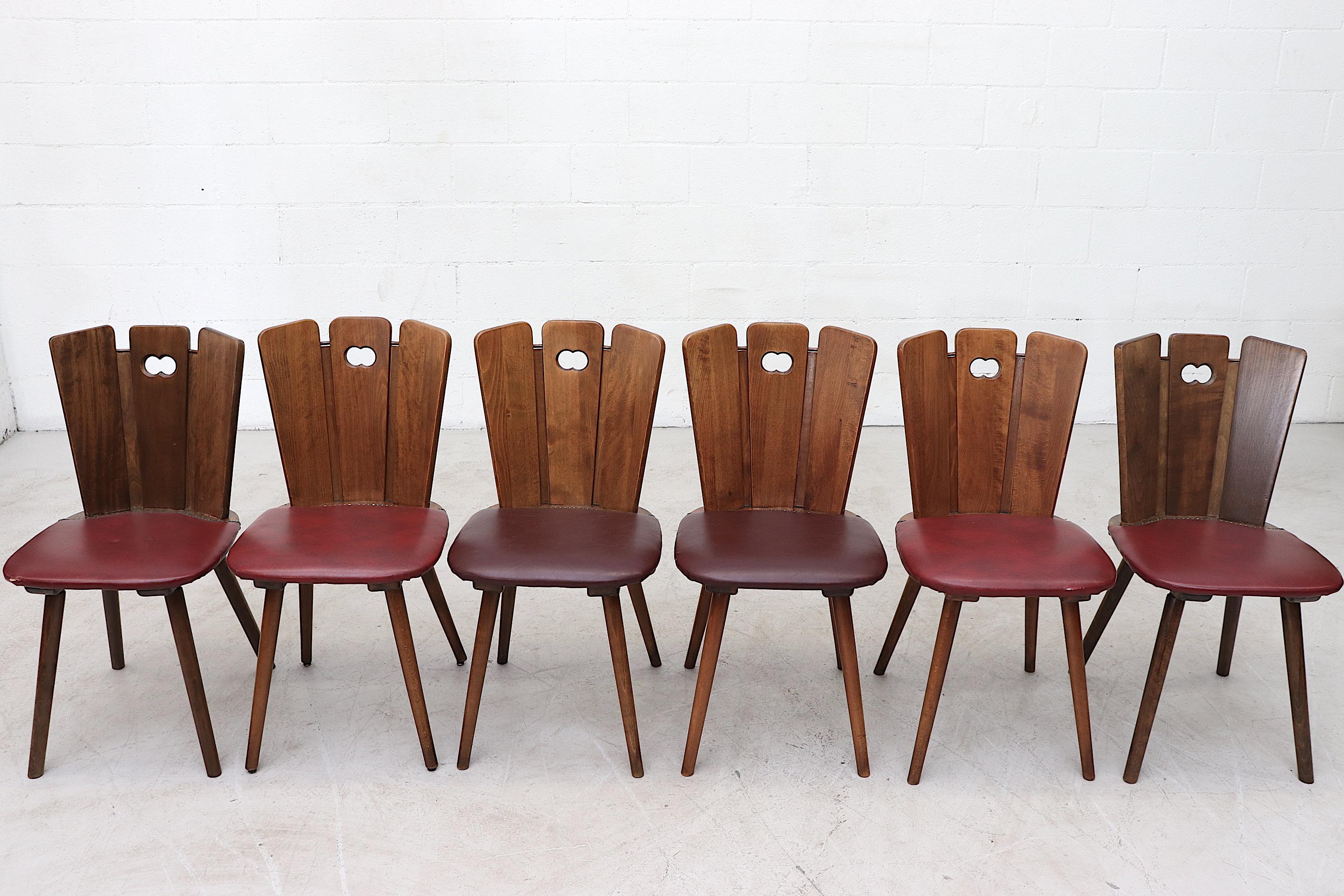 Beautiful Gilbert Marklund Style Brutalist Dining Chairs with Fan-Top Seat Backs, Original Vinyl Seats and Nail-Head Detail. Lightly Refinished Wood. In Original Condition with Visible Tears on Seats. In need of new upholstery. Wear Consistent to