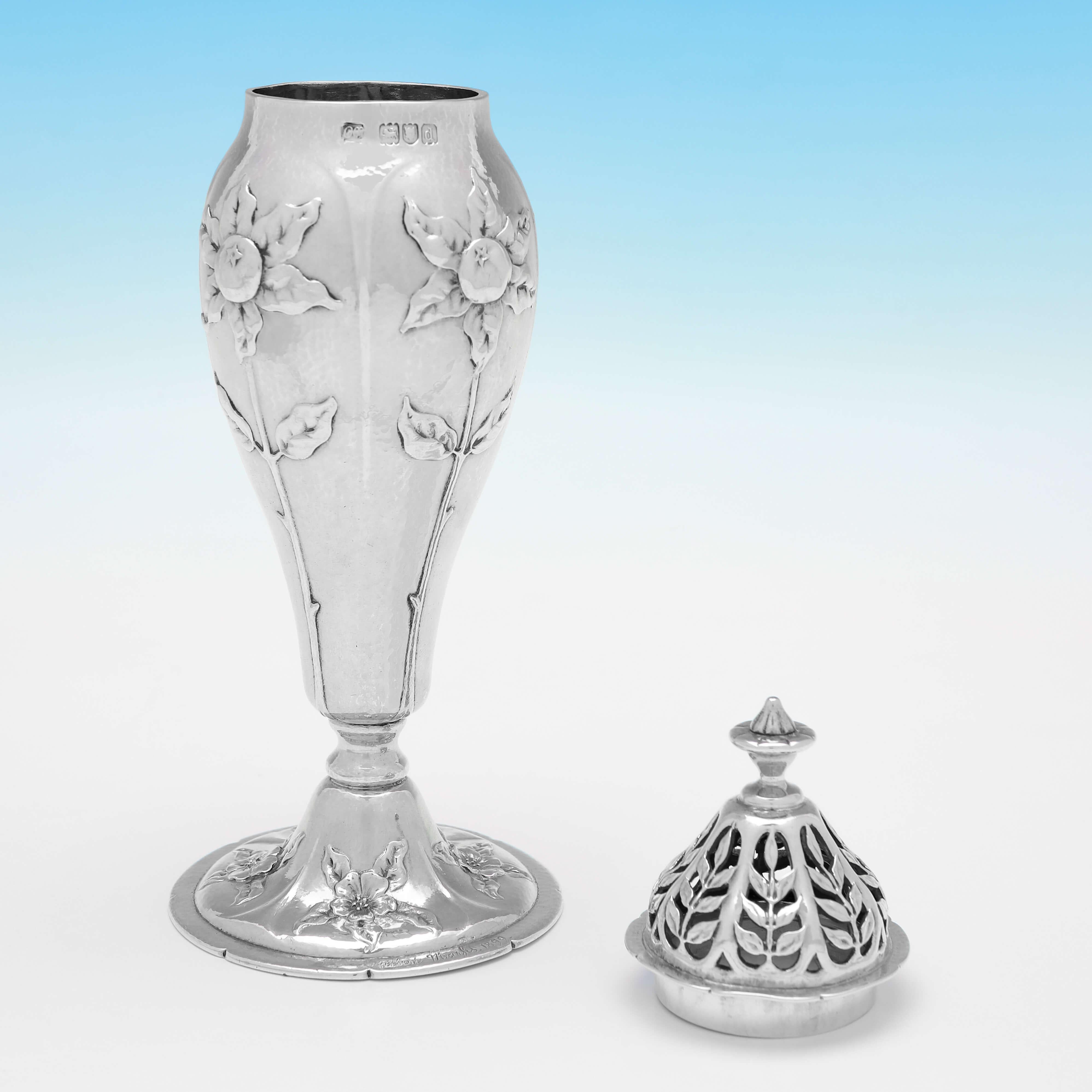 Hallmarked in London in 1899 by Gilbert Marks, this stunning, Antique Sterling Silver Sugar Caster, is in the Arts & Crafts / Art Nouveau taste, wonderfully chased with sunflowers to the body and flowers to the base. 
The caster is Signed and dated