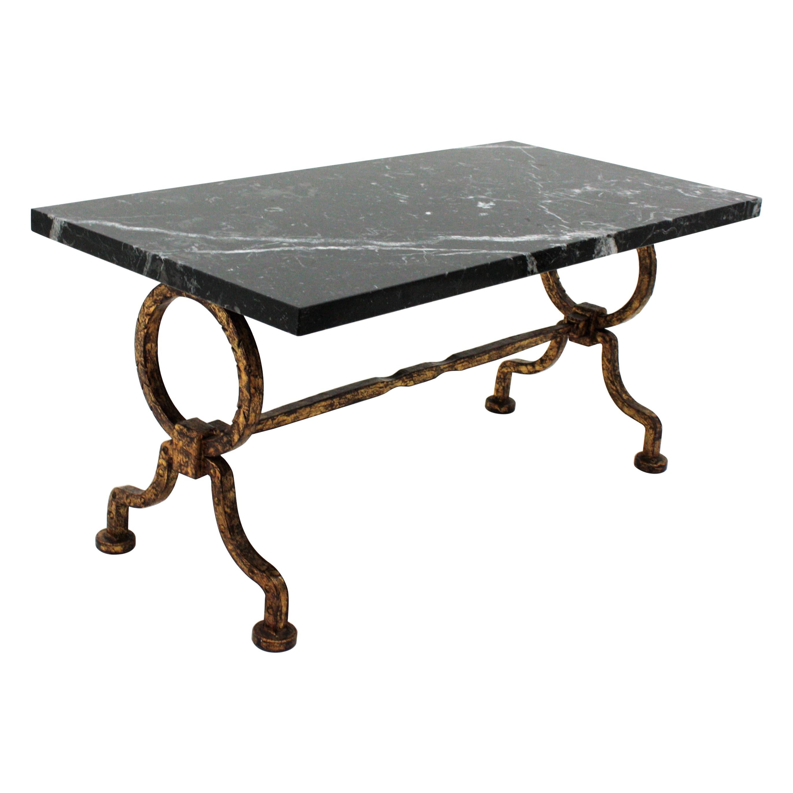 Beautiful Gilbert Poillerat wrought iron low table with black and white marble top. France, 1940s.
Stylish shapes and dramatic black marble top with white veins.
Very good condition.
Original gold leaf gilding and beautiful aged patina.
Use it
