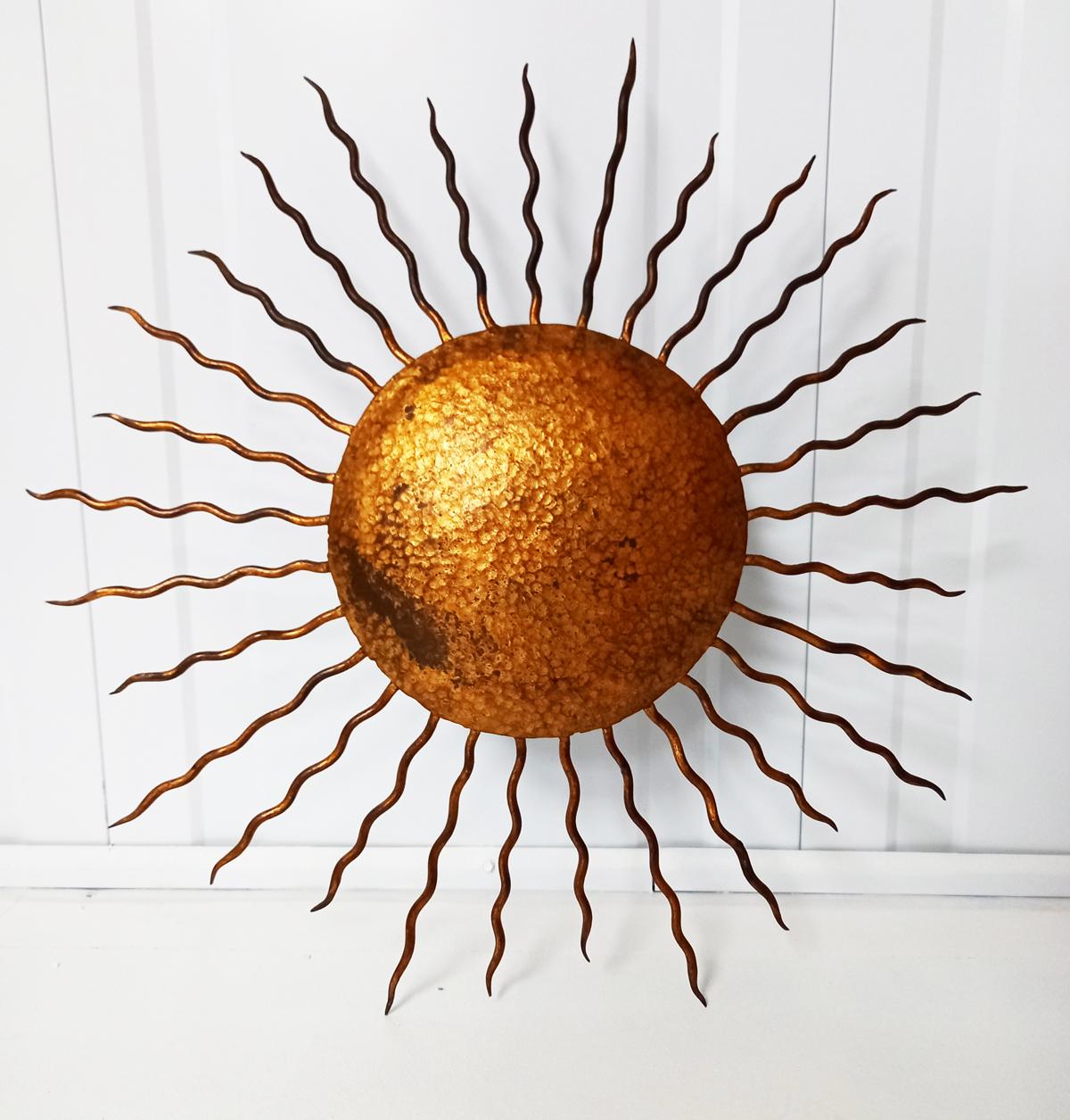 Wrought gilt hand-forged iron sunburst flush mount ceiling lamp or wall mount fixture. France, 1930s, 1940s.
This brutalist-style light fixture has a design Att. to Gilbert Poillerat.
This sunburst was entirely made with hand-forged iron and