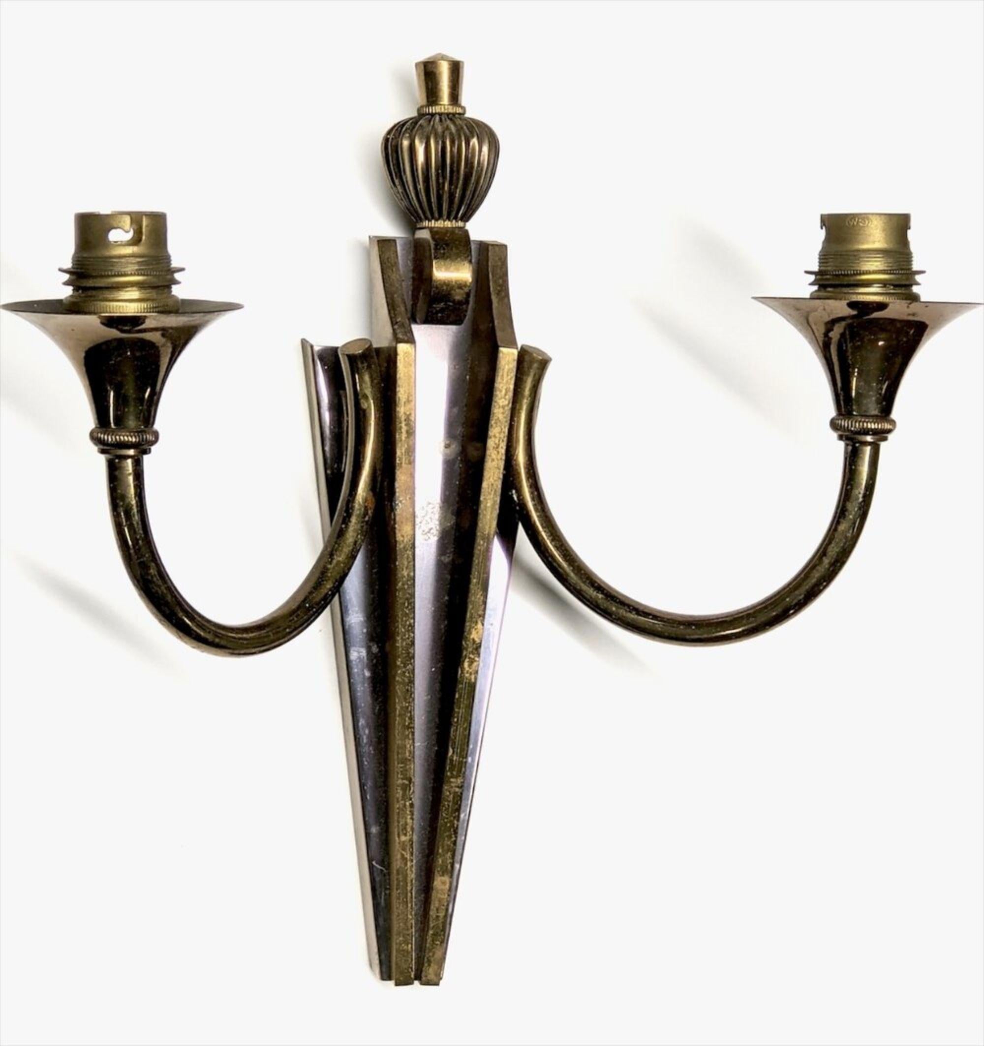 French 1940s Art Deco three two-branch sconces by Gilbert Poillerat. Available singly or pair or group. Bronze and patinated bronze. Measures: 12.5” wide x 4” deep x 10” high.