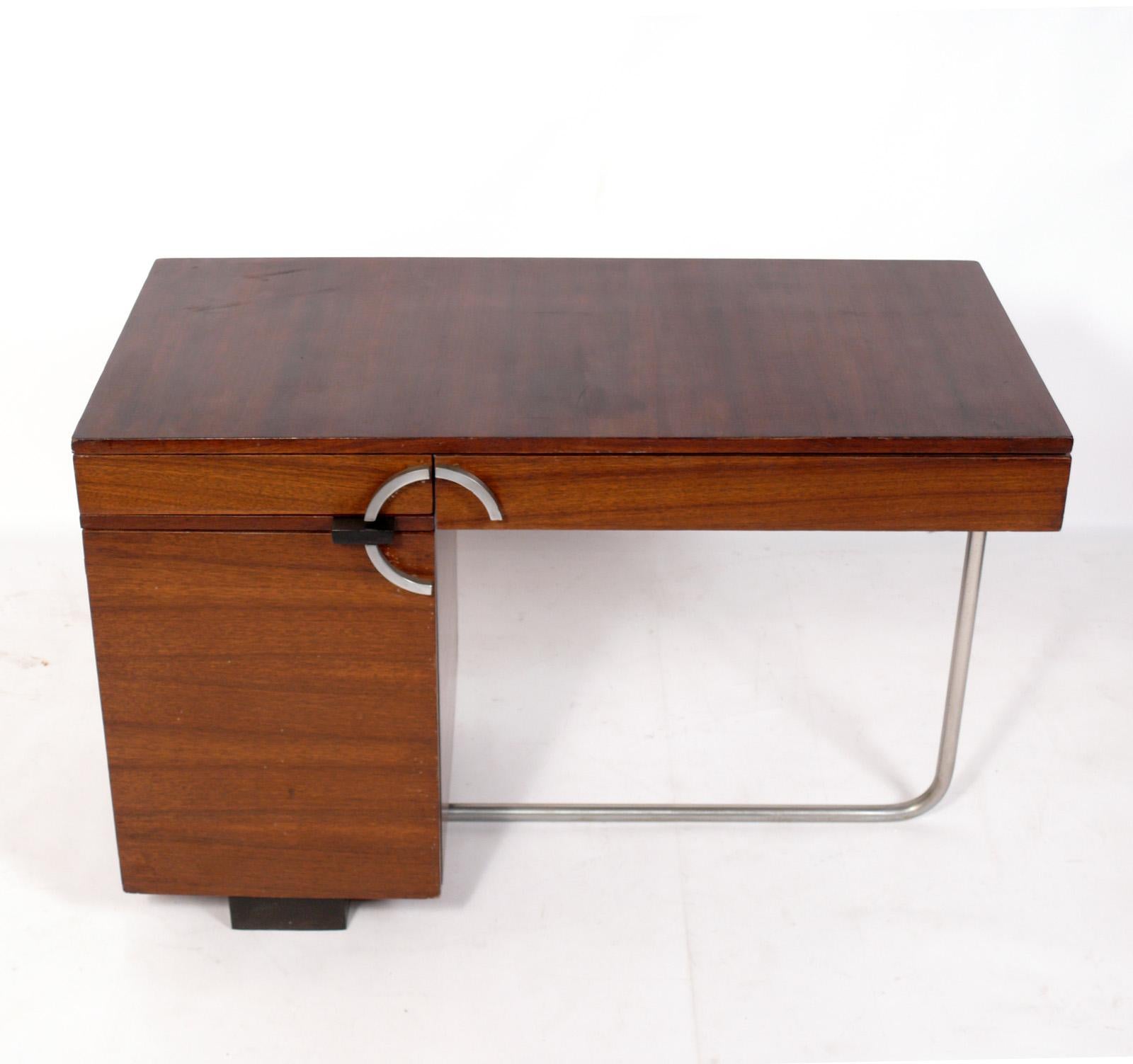 Streamlined Art Deco Desk, designed by Gilbert Rohde for Herman Miller, circa 1930s. It is executed in beautifully grained paldao wood. This desk is currently being refinished and can be completed in your choice of finish color, including the