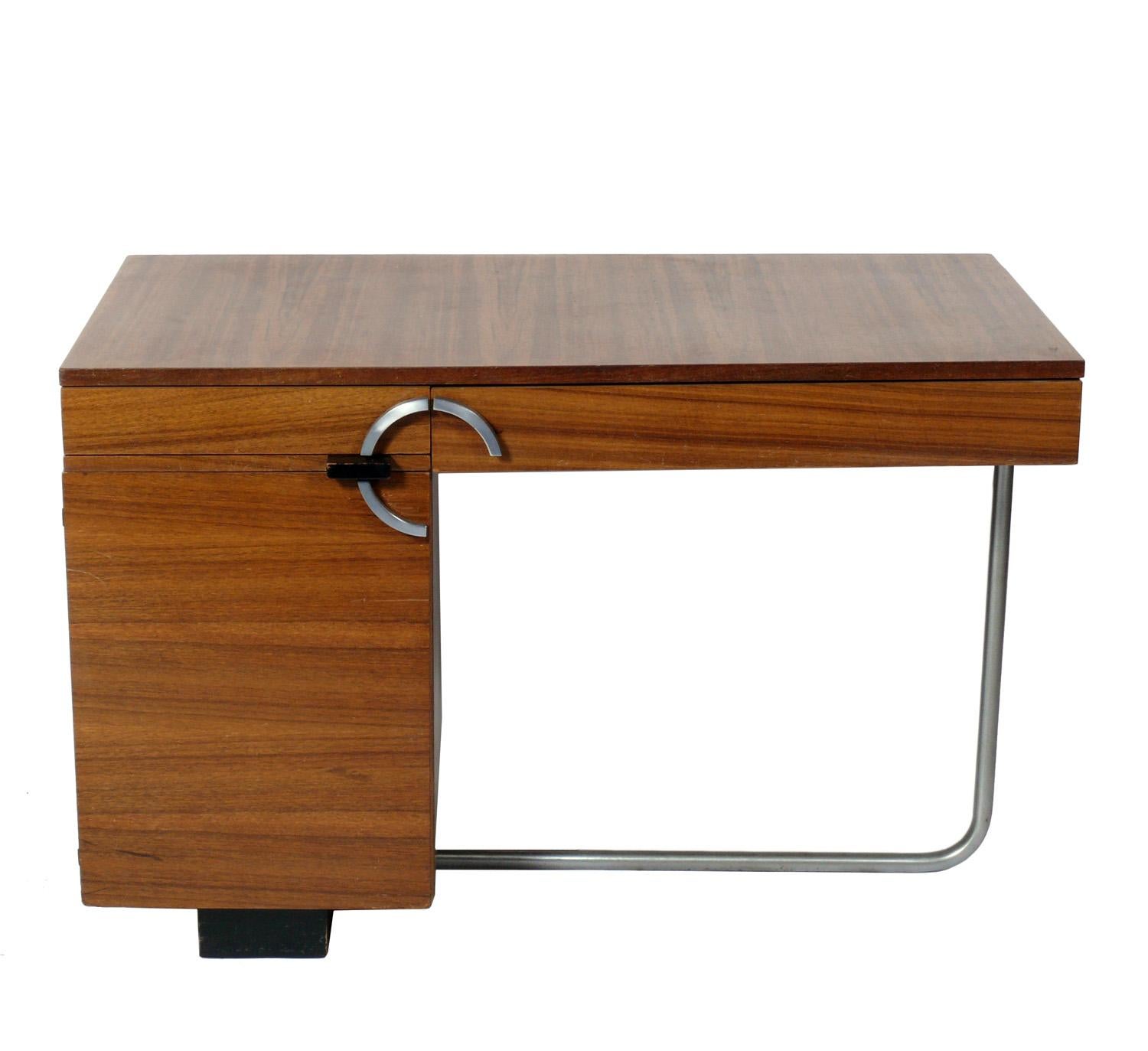 Streamlined Art Deco Desk, designed by Gilbert Rohde for Herman Miller, circa 1930s. It is executed in beautifully grained paldao wood. Please see our other 1stdibs listings for other Rohde Paldao Group pieces to complete your home office. This desk