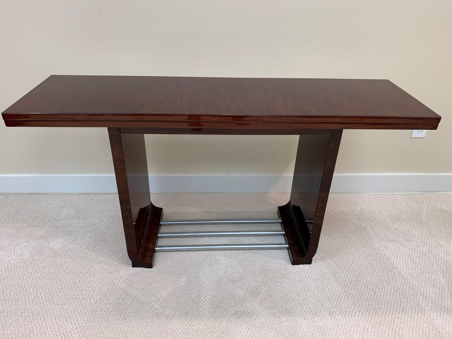 Gilbert Rohde Art Deco flip-top dining console for Herman Miller. Gilbert Rohde designed this American Art Deco console dining table in 1934 for the Herman Miller Furniture Company. It is No. 3435 from his East India Laurel Group. The console is