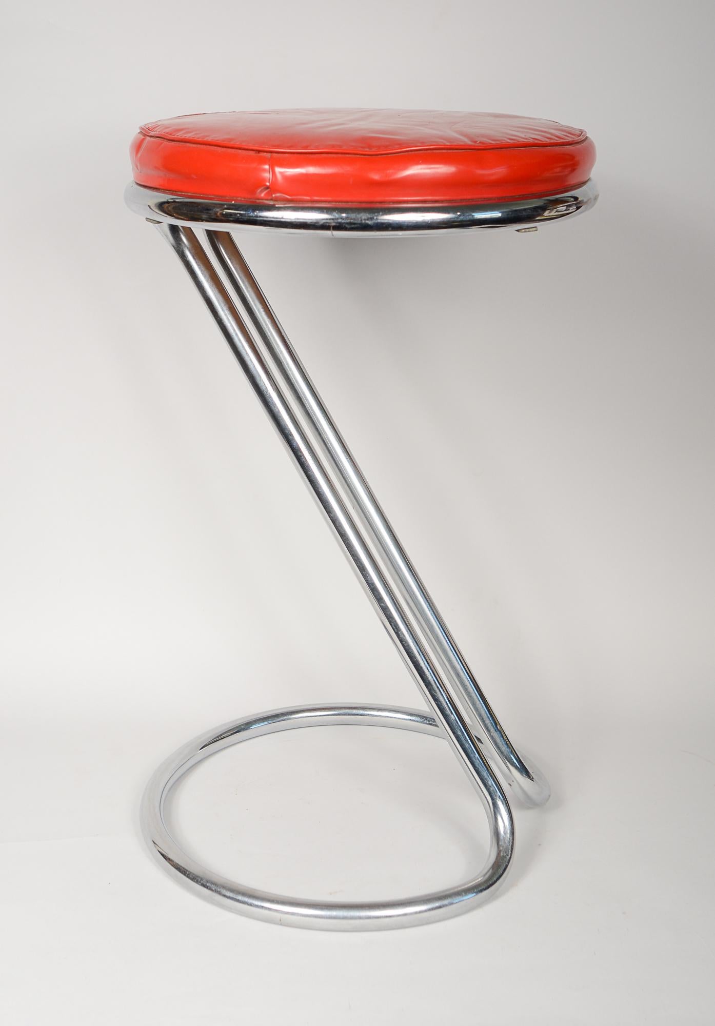 Z stool designed by Gilbert Rohde for Troy Sunshade Company. The stool is in original condition. The chrome shows a little surface wear. The original upholstery has a tear repaired with tape.