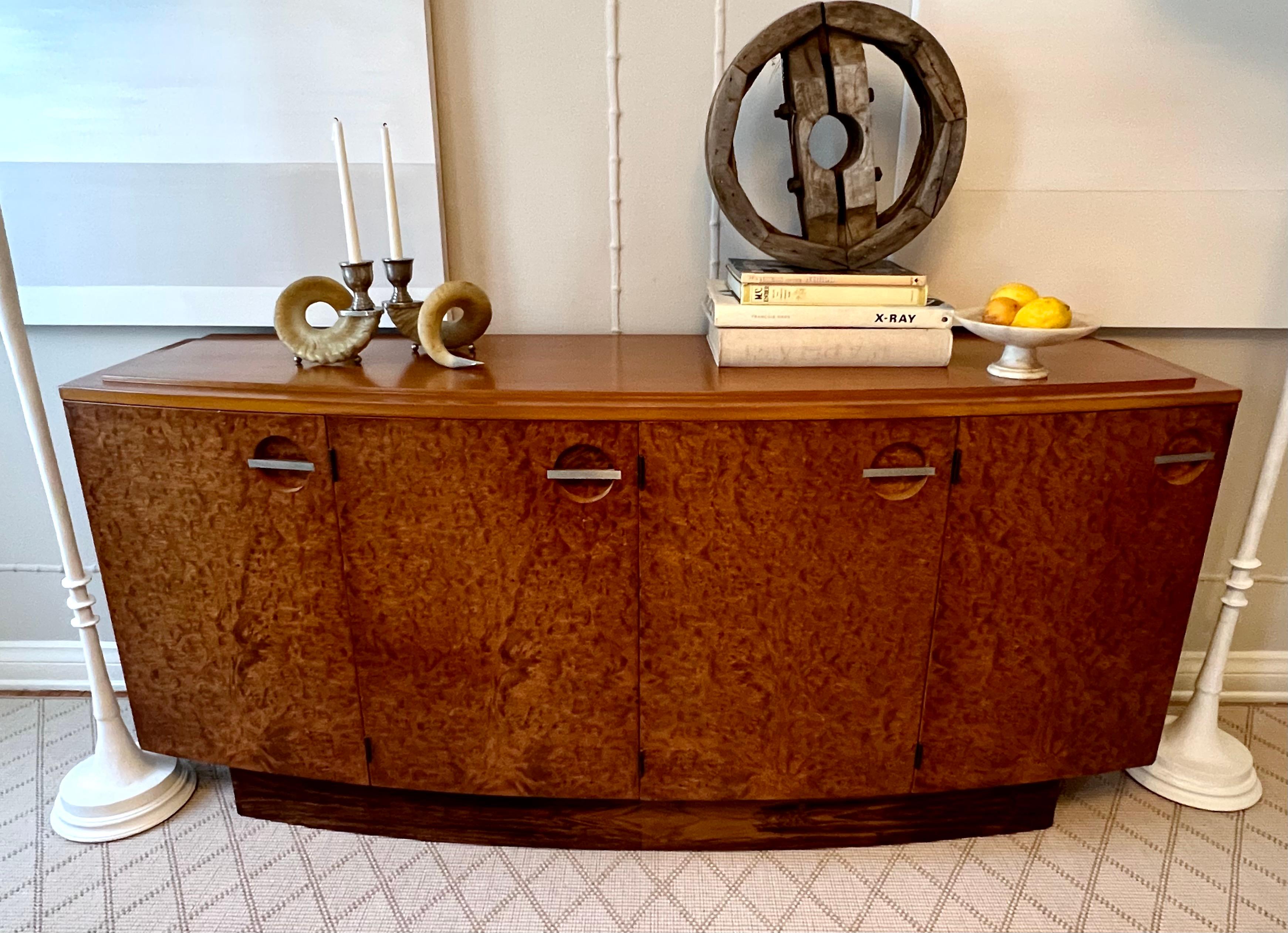 Gilbert Rohde for Herman Miller Art Deco burl mahogany sideboard buffet - the classic Burl buffet or sideboard has an elegantly curved front panel with four doors and steel pulls. The top features a detailed and raised top. Recently refinished and