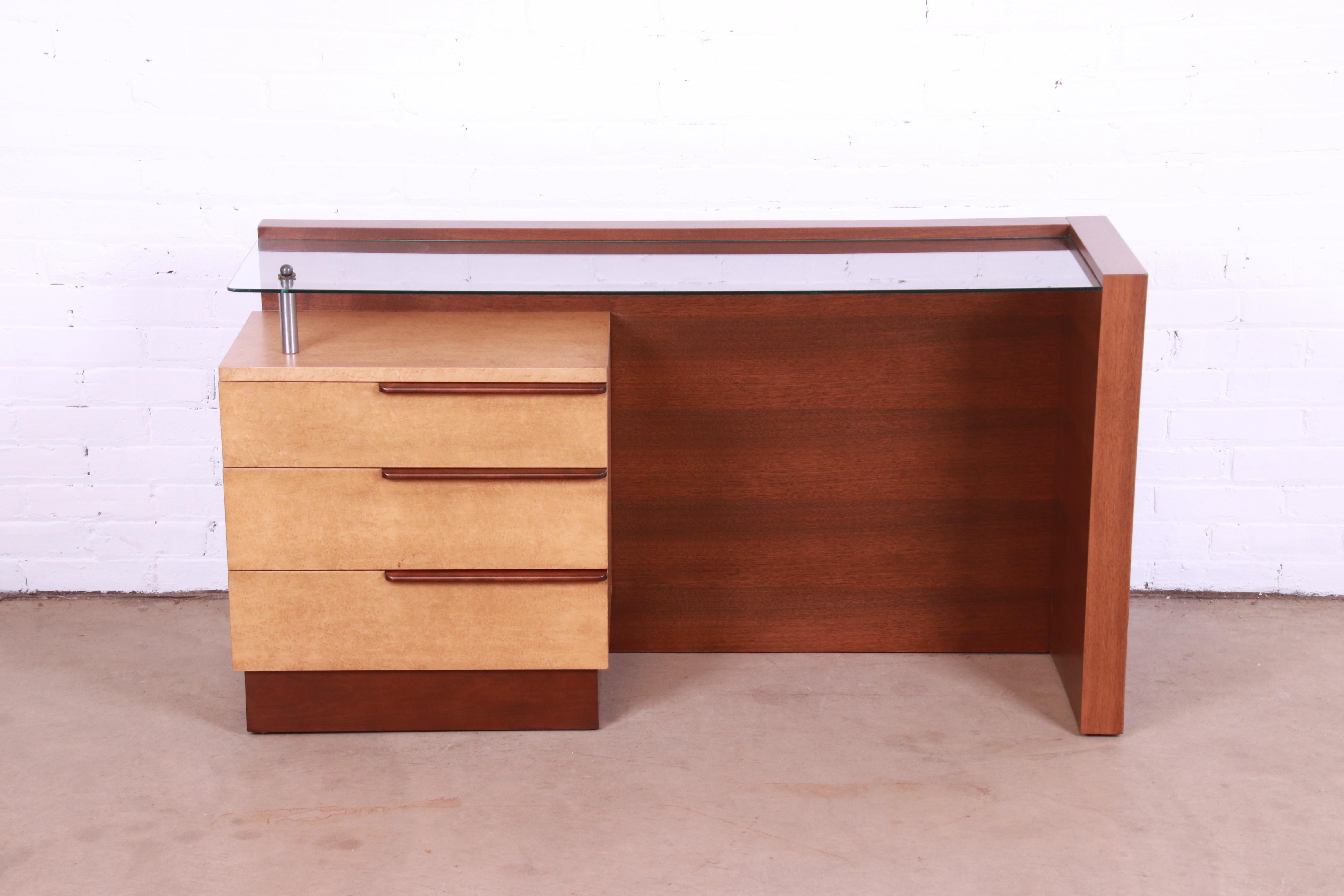 An extremely rare and exceptional Art Deco or mid-century modern vanity or desk

By Gilbert Rohde for Herman Miller

USA, Circa 1936

East Indian laurel wood and birdseye maple, with glass top.

Measures 52.25