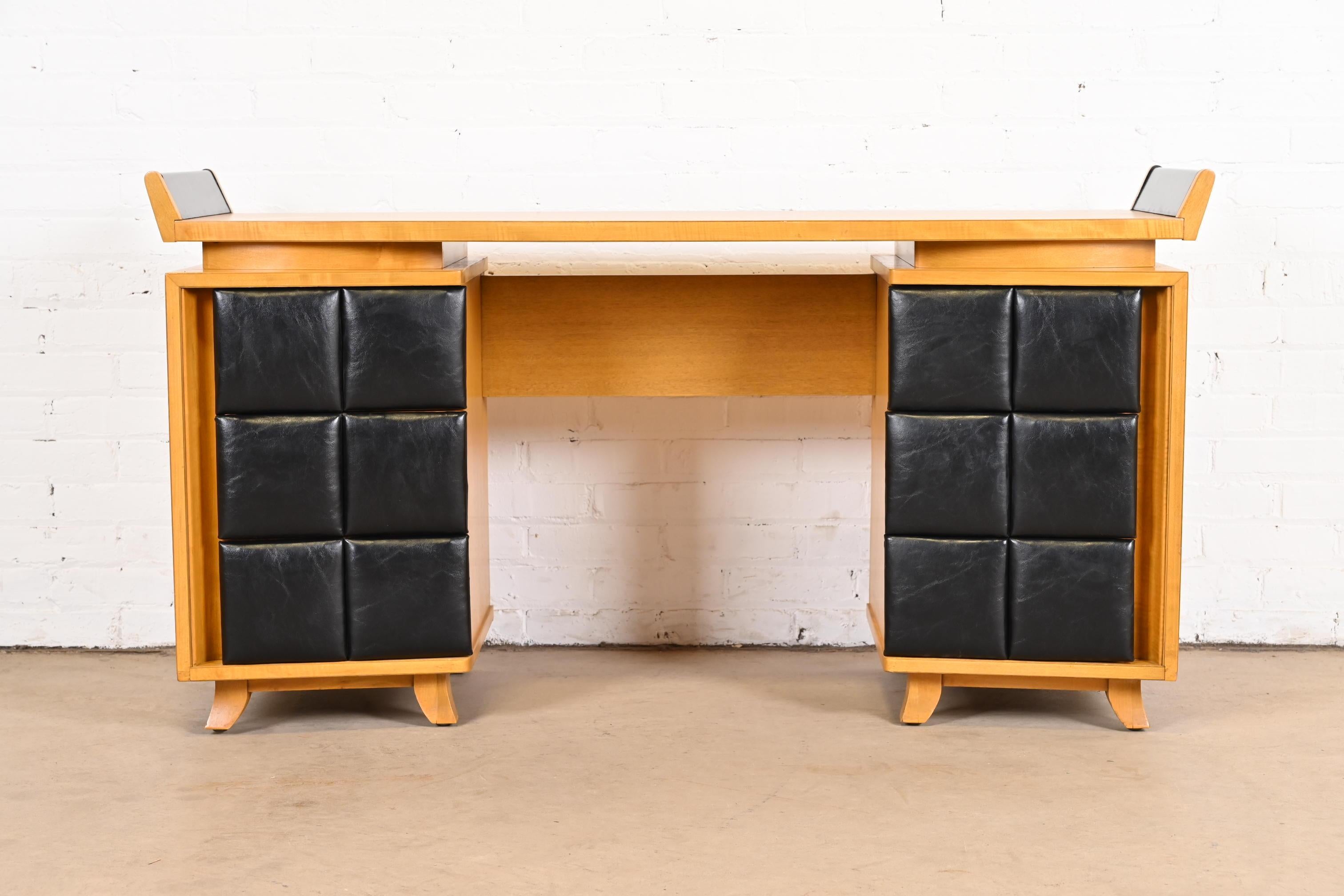 An exceptional Art Deco or Mid-Century Modern vanity or desk

By Gilbert Rohde for Herman Miller

USA, 1930s

Mahogany, with black leatherette drawer fronts and black lacquered 