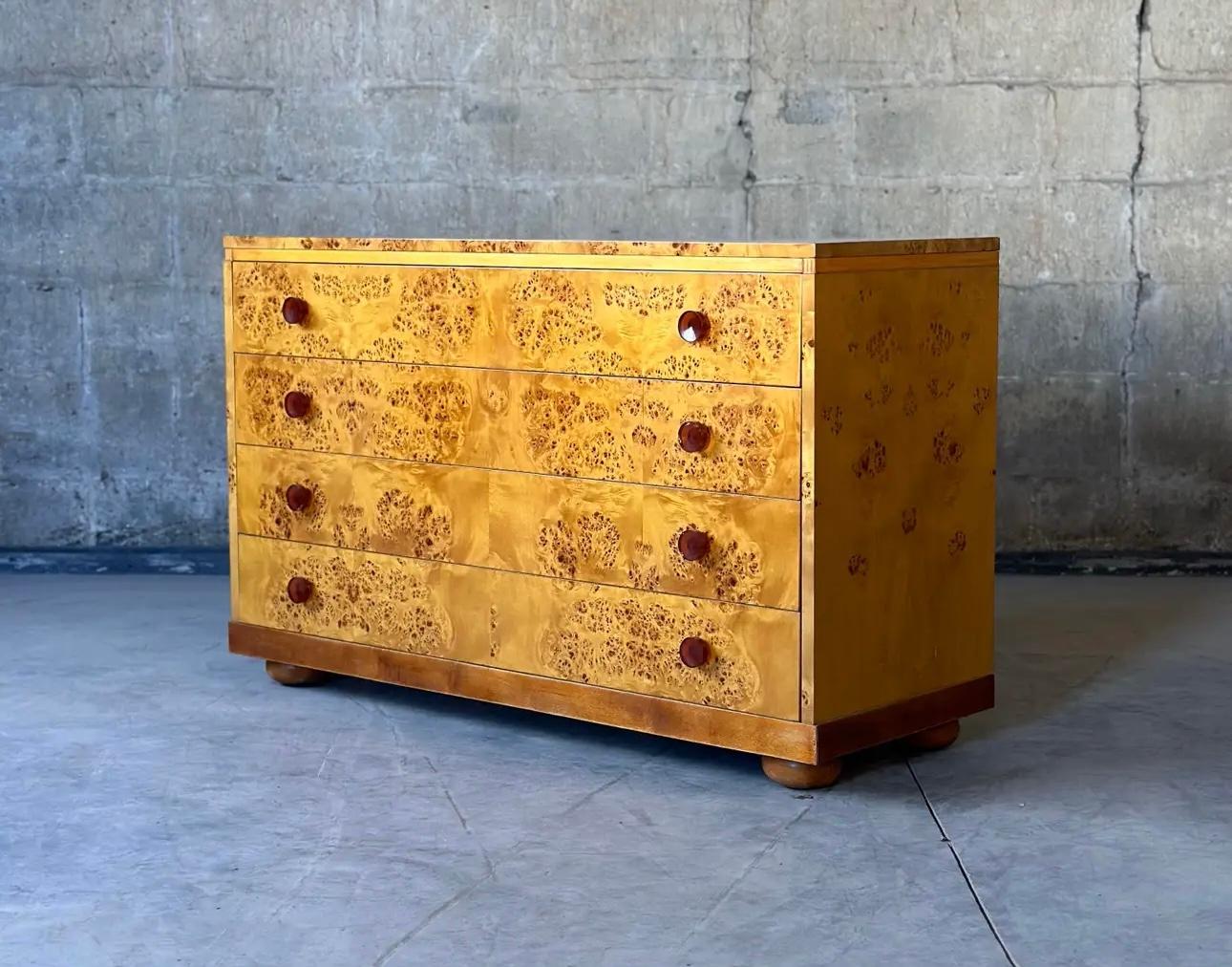 This outrageous Gilbert Rohde for Herman Miller dresser is just beautiful. Covered with burled Birdseye maple, the round Bakelite handles take it over the top.