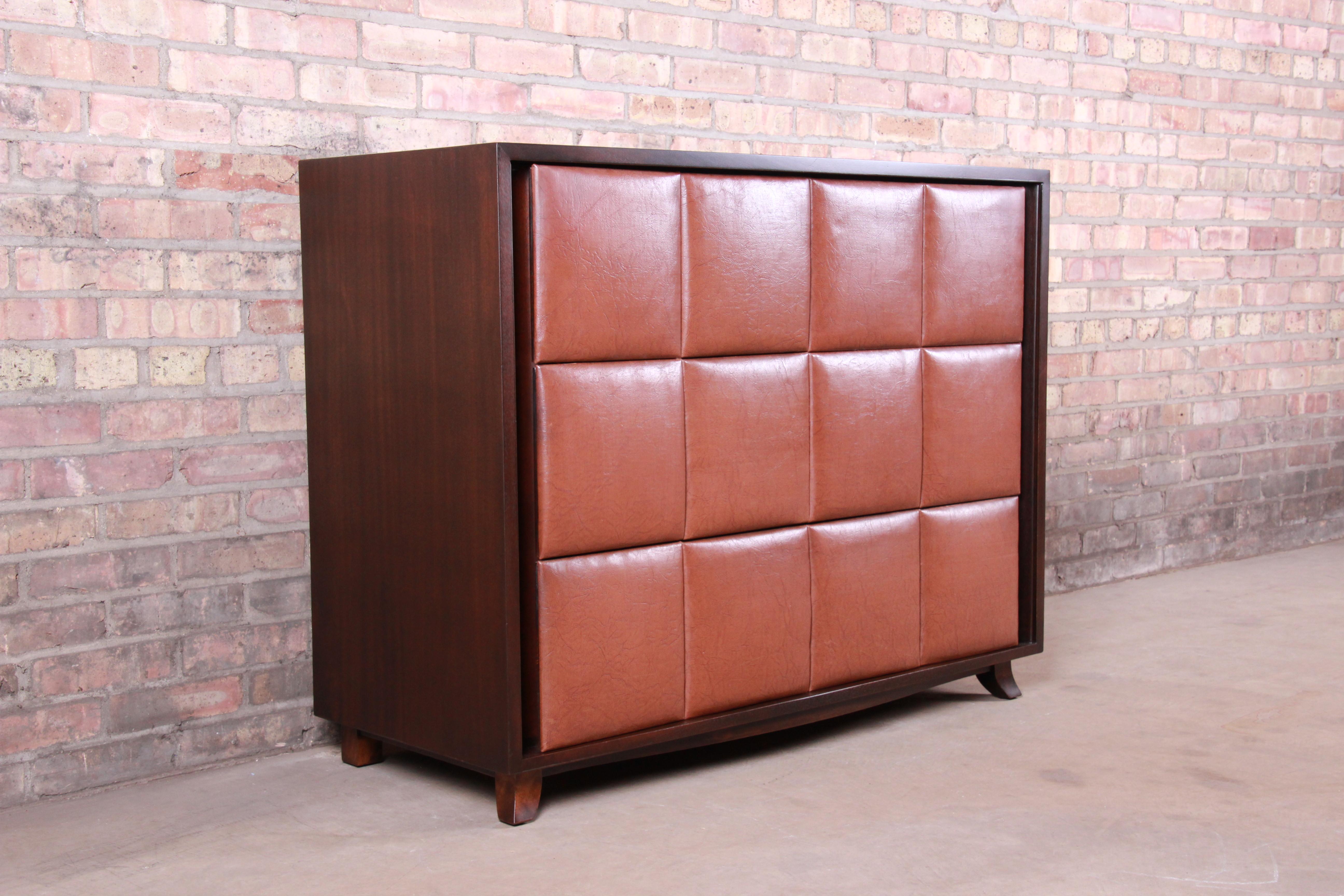 An exceptional Art Deco or Mid-Century Modern three-drawer bachelor chest or large nightstand

By Gilbert Rohde for Herman Miller

USA, circa 1930s

Mahogany case, with Naugahyde drawer fronts.

Measures: 44.25