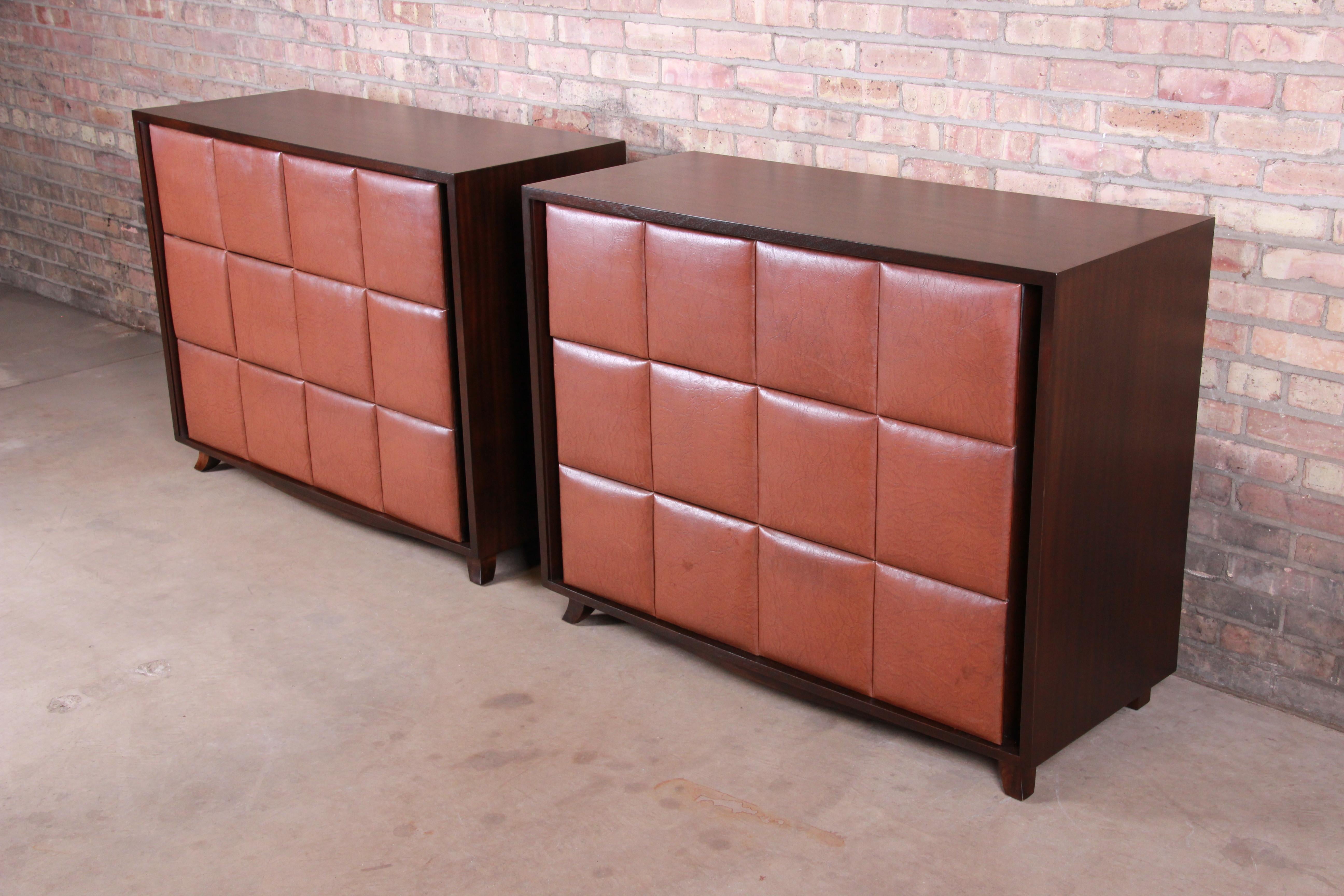 An exceptional pair of Art Deco or Mid-Century Modern three-drawer bachelor chests or large nightstands

By Gilbert Rohde for Herman Miller

USA, circa 1930s

Mahogany cases, with Naugahyde drawer fronts.

Measures: 44.25