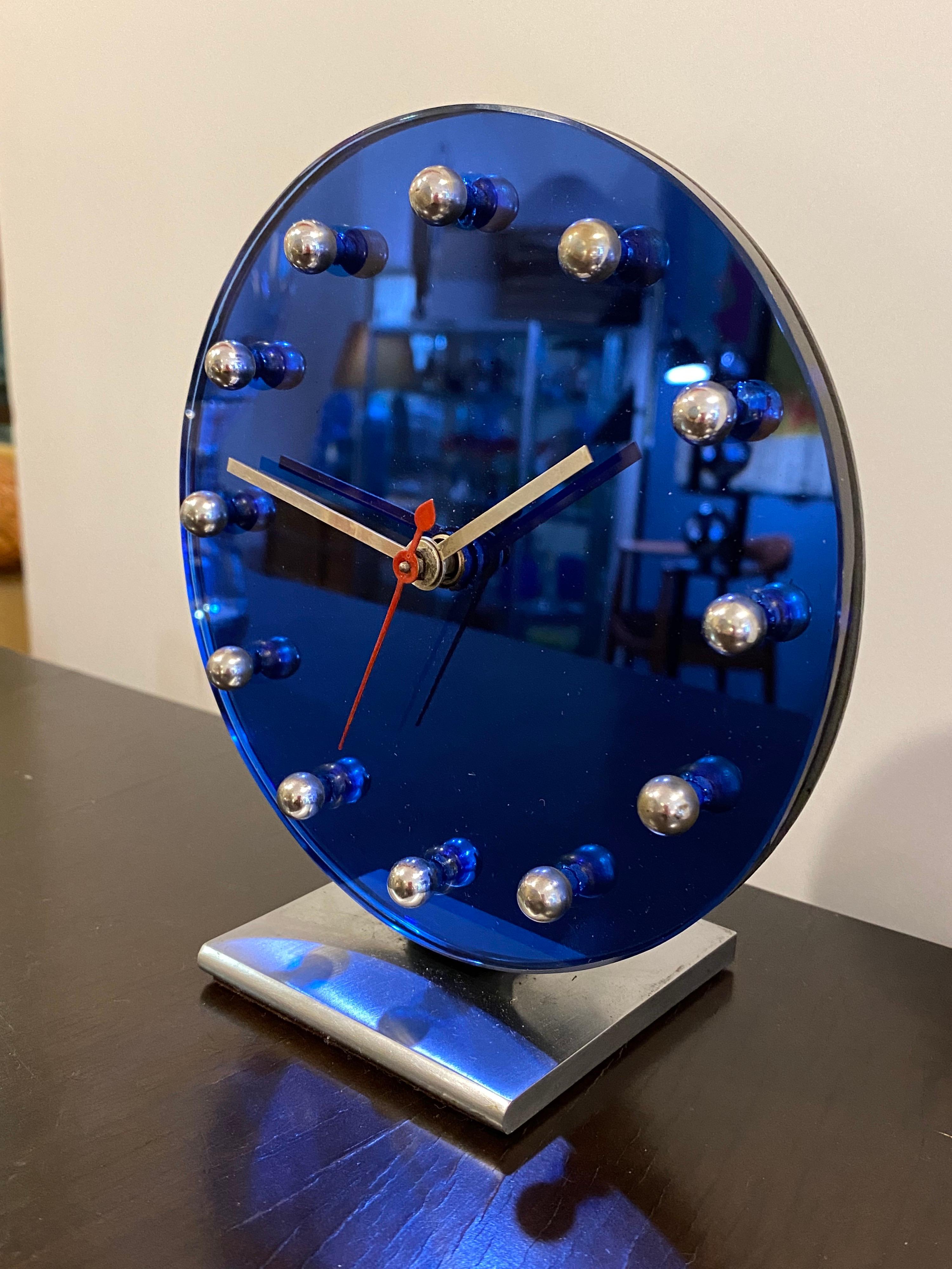 Gilbert Rohde for Herman Miller blue mirror table clock. Rohde introduced a series of clocks in the early 30's that are some of the most amazing designs out there! This example simplifies a clock down to its most basic elements. One of the most