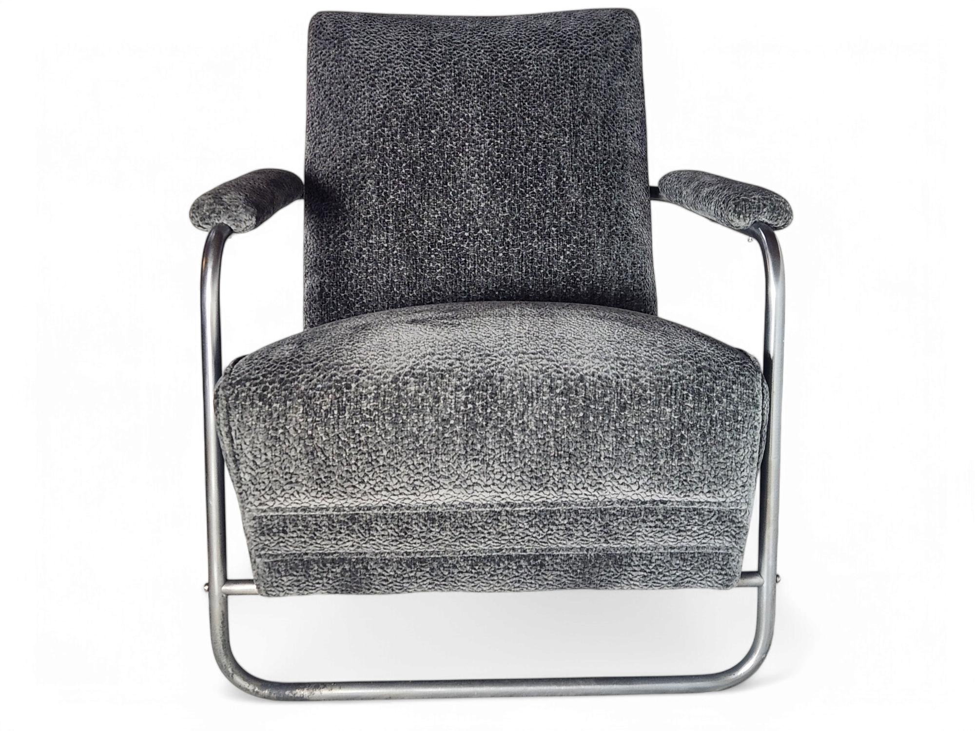 A Gilbert Rohde classic nickel plated lounge chair designed for Herman Miller in 1936.
Freshly re-upholstered in a thick dark grey boucle and very comfortable.
The frame shows it's age in places.