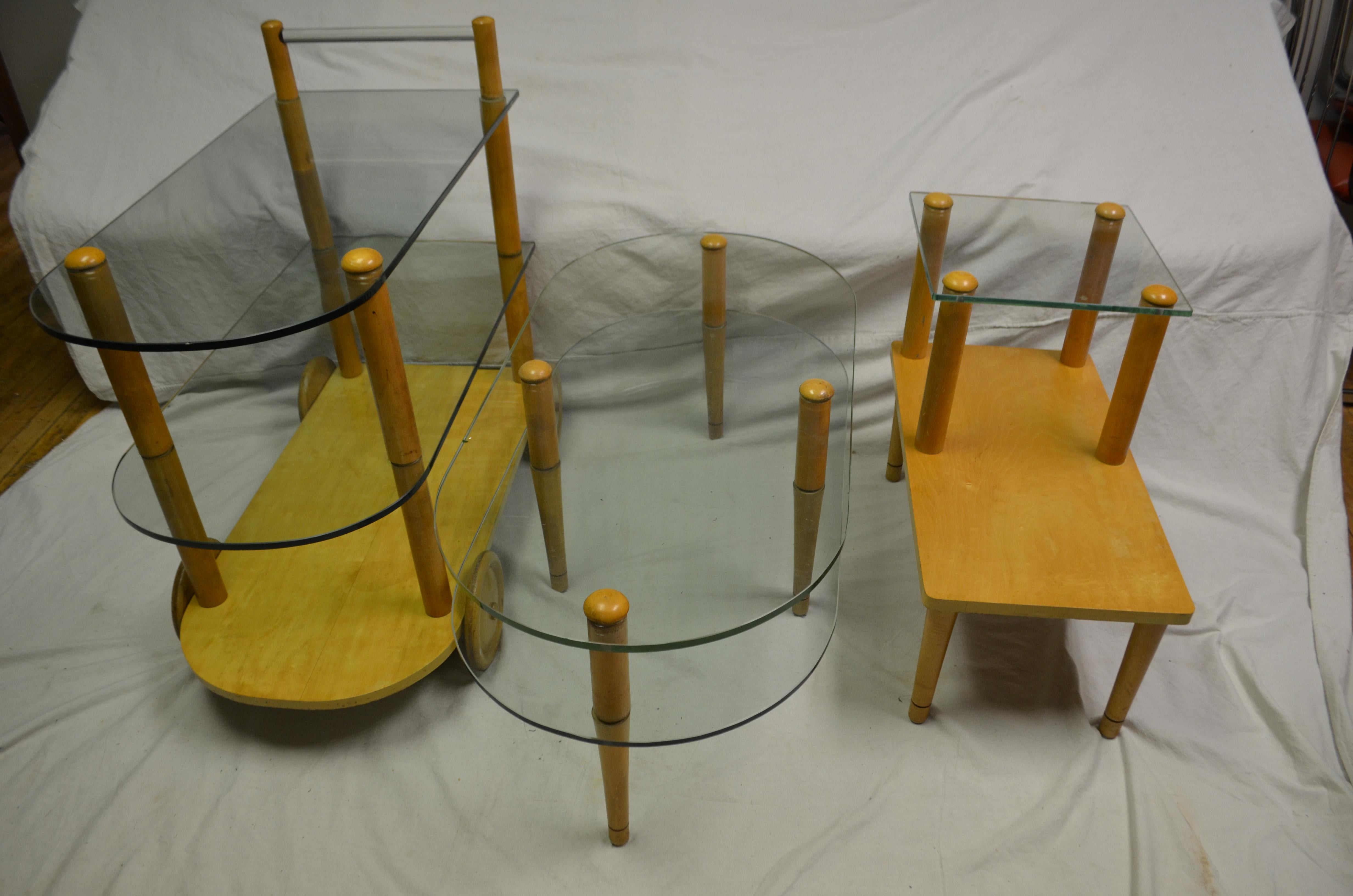 Designer Gilbert Rohde's set of three pieces in midcentury style of glass and wood. Sculptural in presentation and functional for home or office. Rohde was the Harbinger of the modern era and the designer often credited with transforming Herman