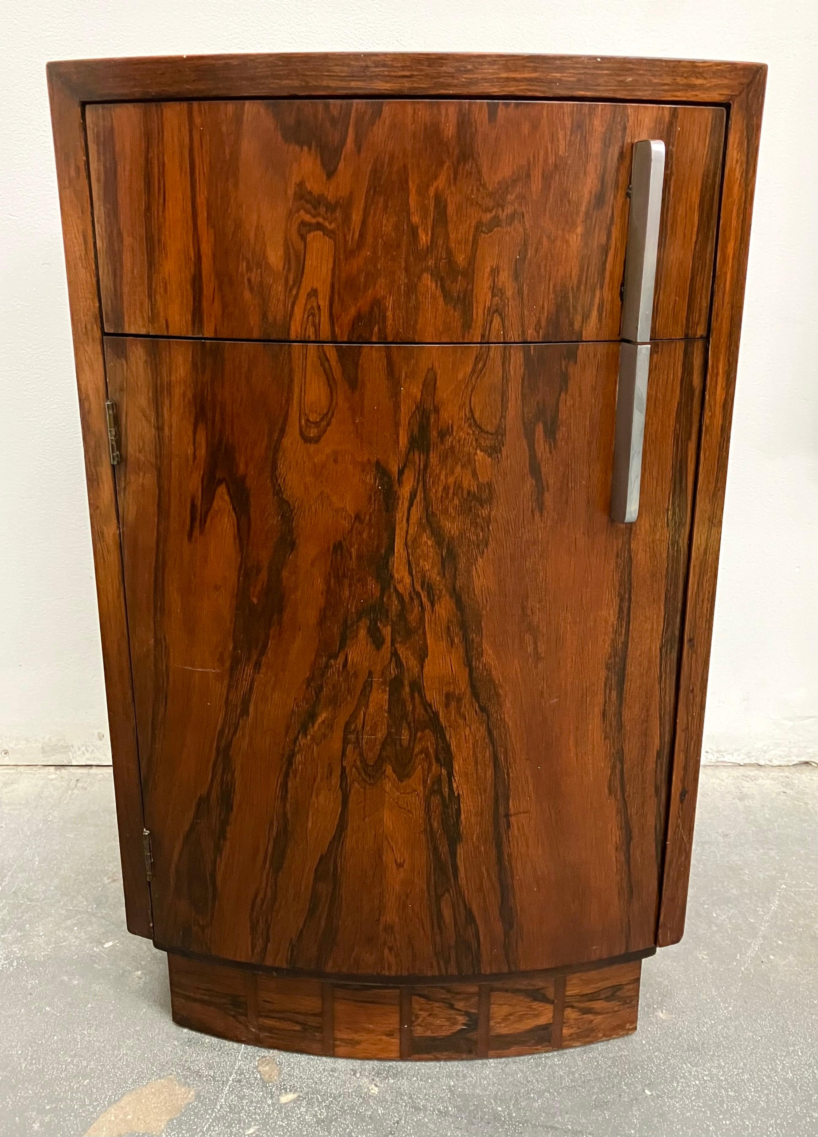 Rarely seen nightstand by Gilbert Rohde in beautifully figured burled rosewood with thin steel pulls. Features one drawer and a larger lower compartment. Model # 3770 for Herman Miller.
