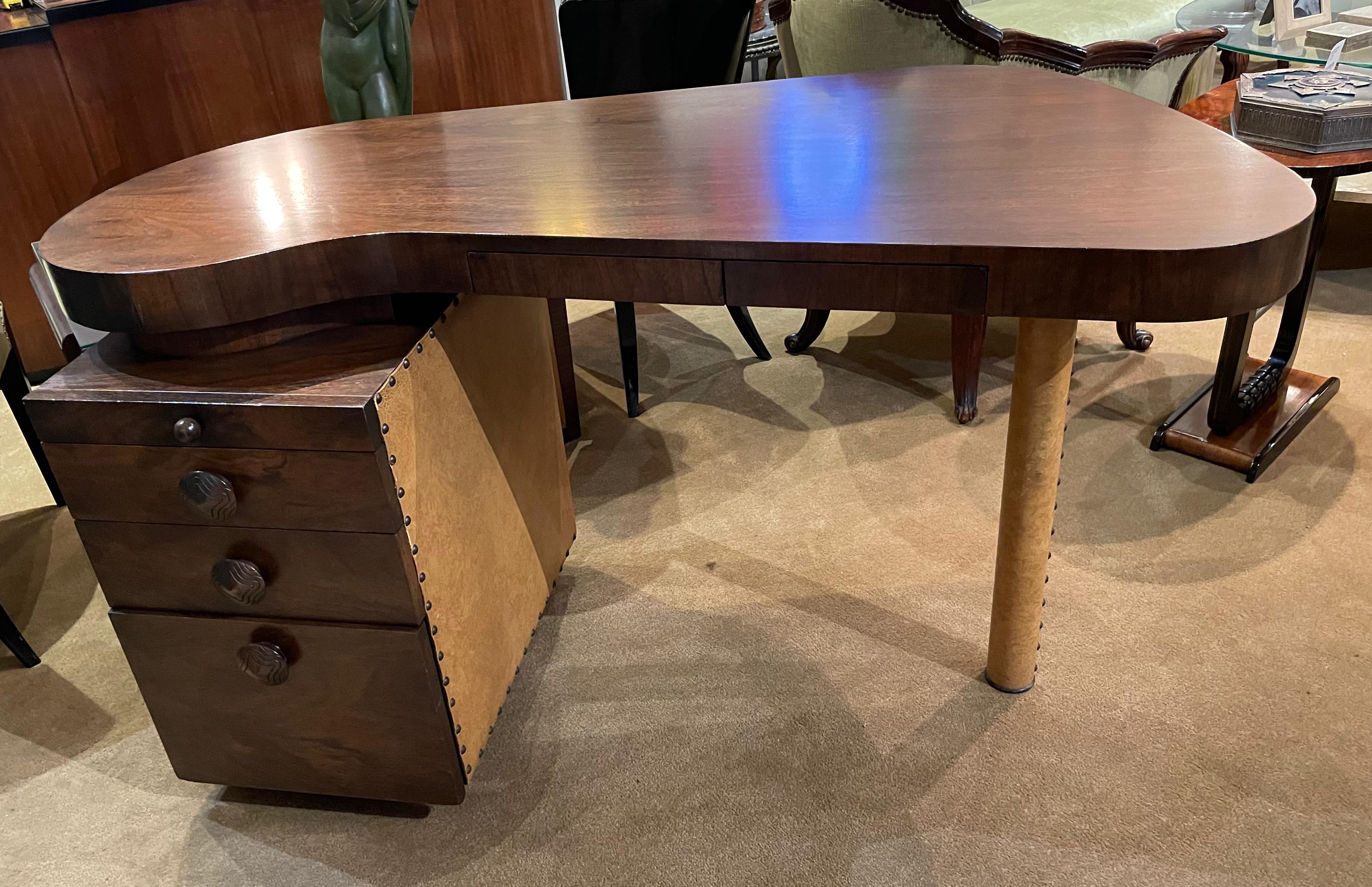 This Gilbert Rohde paldao desk was manufactured between 1935-1940 by the Herman Miller Company. It is in original condition showing only the very lightest signs of wear. It still has the original leatherette covering on the legs. This stylized desk