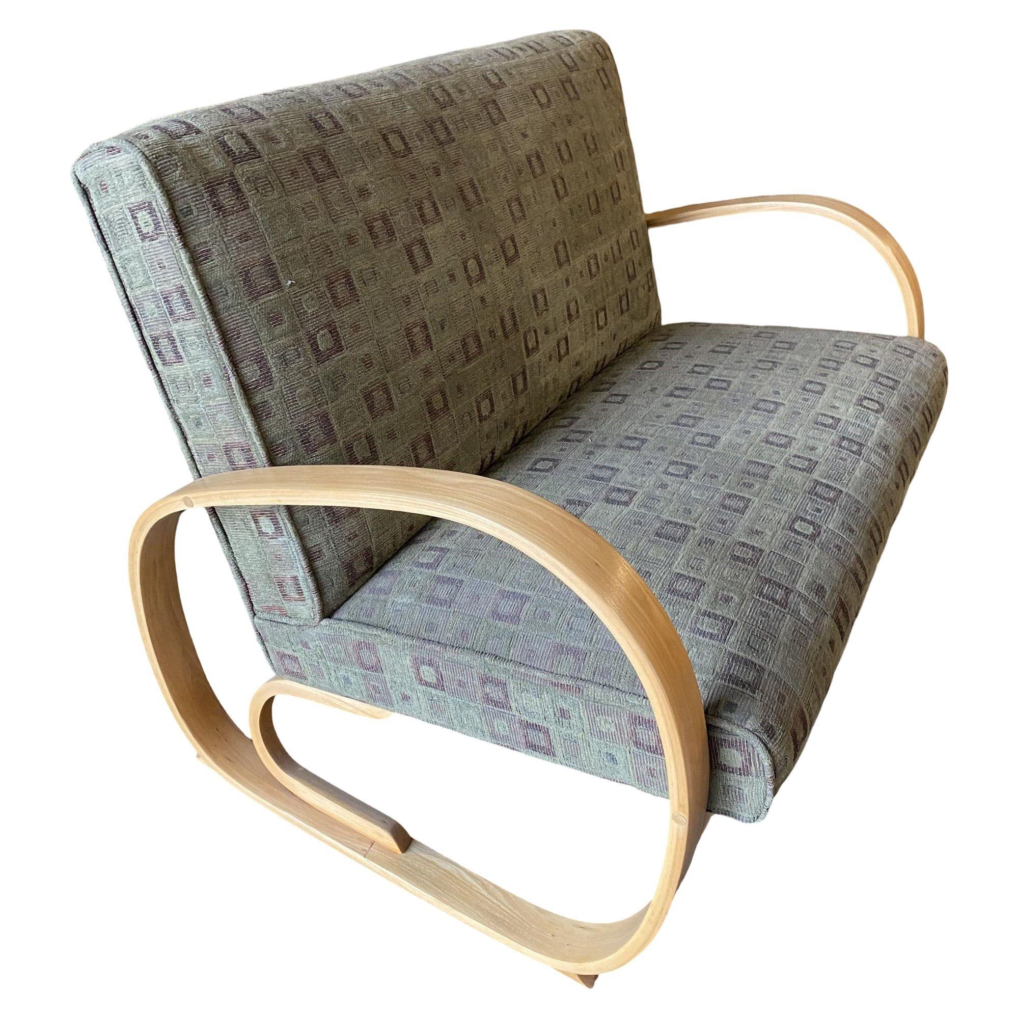 Gilbert Rohde designed streamline settee and lounge chair featuring a matching set both with a floating set and shaped Art Deco speed arms.

Measurements
Settee: 45