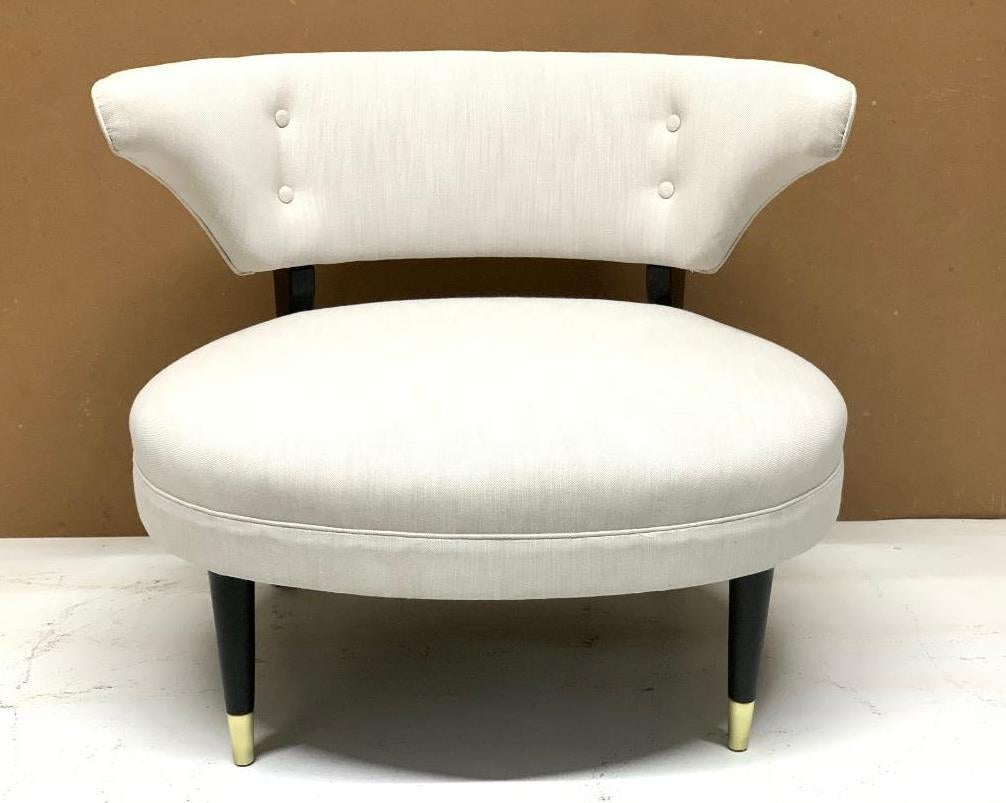 Gilbert Rohde style lounge or slipper chair with a black wood frame and brass sabots to the front feet. Mid-Century Modern.