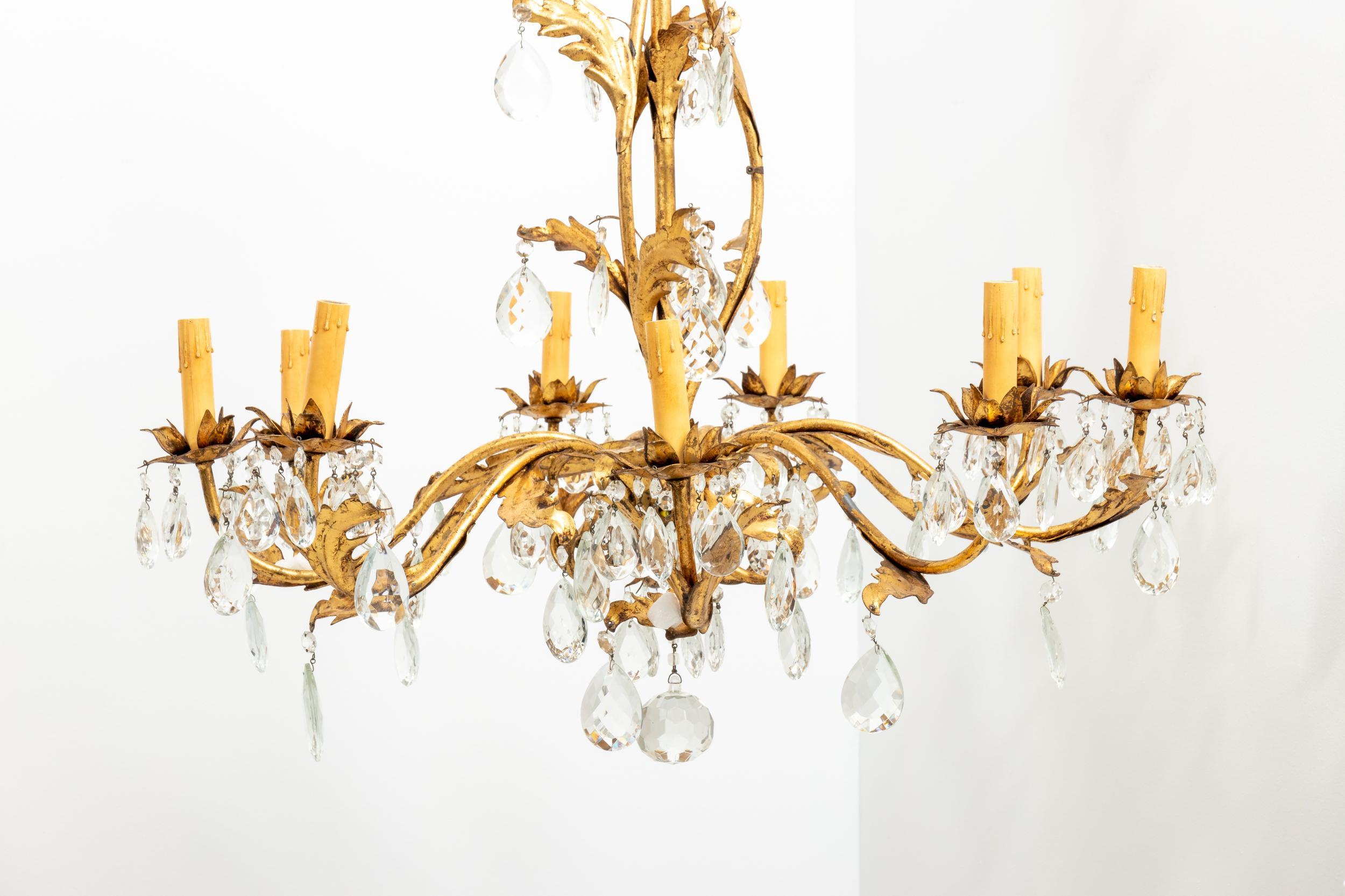 Mid-20th century crystal and gilt chandelier with nine arms. Please note of wear consistent with age including finish loss to the gilded leaves. Shades not included.