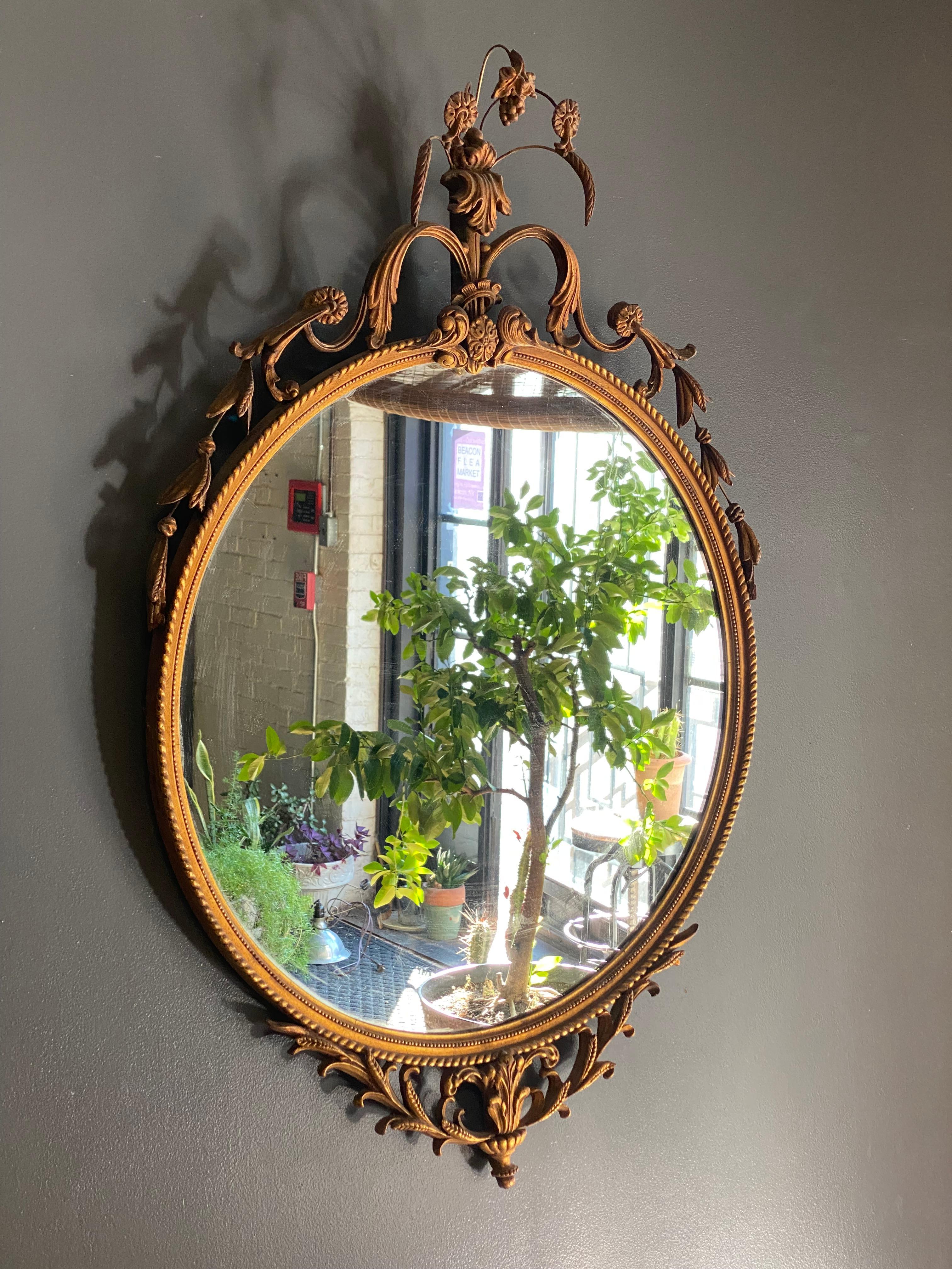 Neoclassical Adams Style gilded gesso circular mirror. After the design technique of Scottish architect,  William Adams, and sons, Robert and James, who followed in their Father's footsteps. This particular piece dates circa 1920-40. Excellent