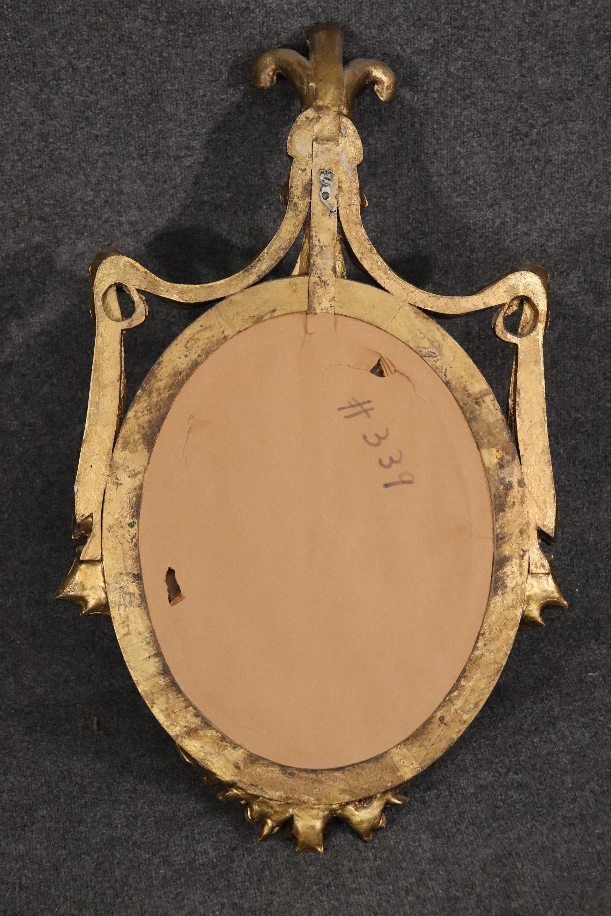 Mid-20th Century Gilded Adams Style Oval Mirror with Decorative Elements