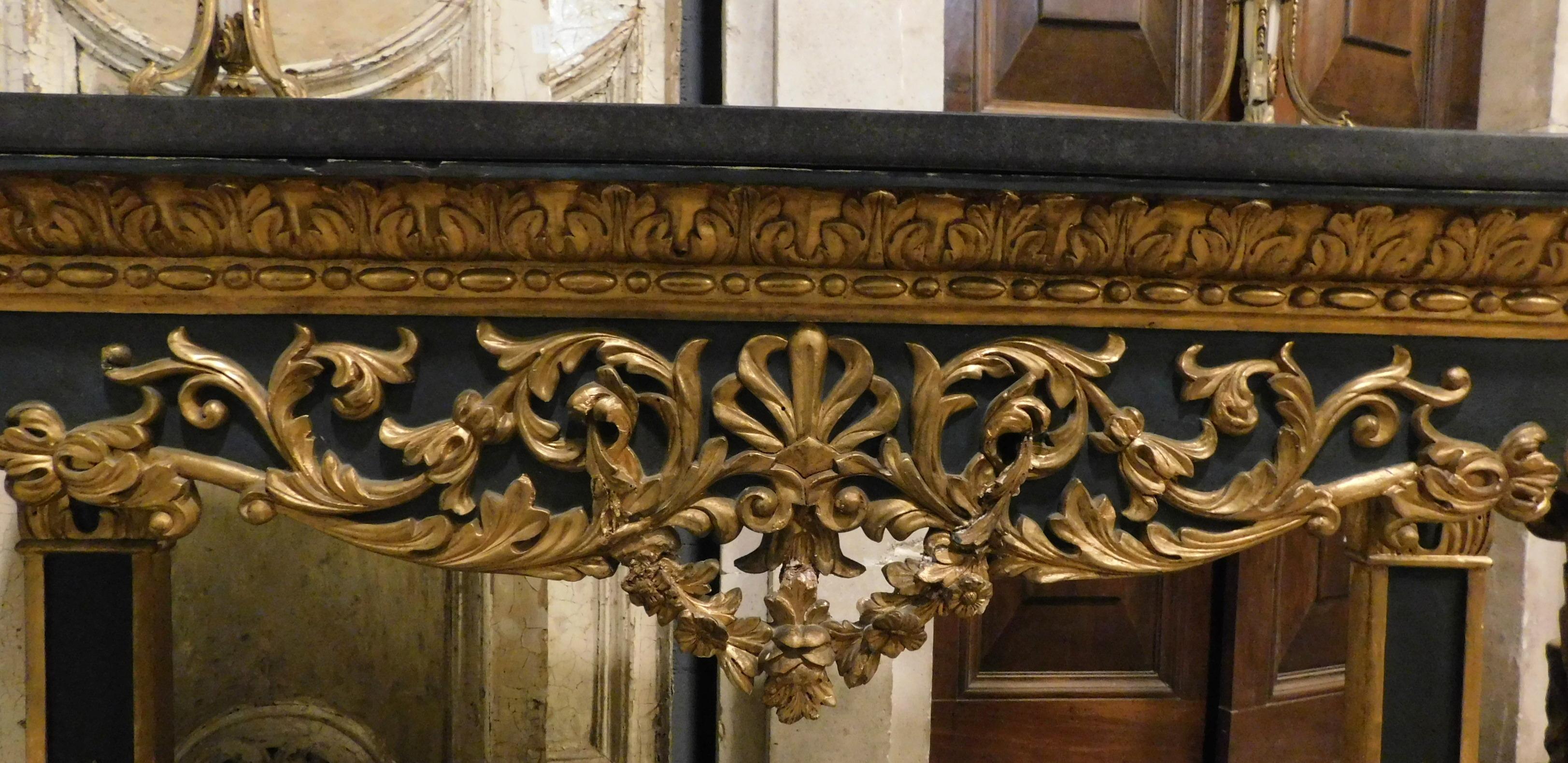Hand-Carved Gilded and lacquered console in richly carved wood, black marble top, Italy For Sale
