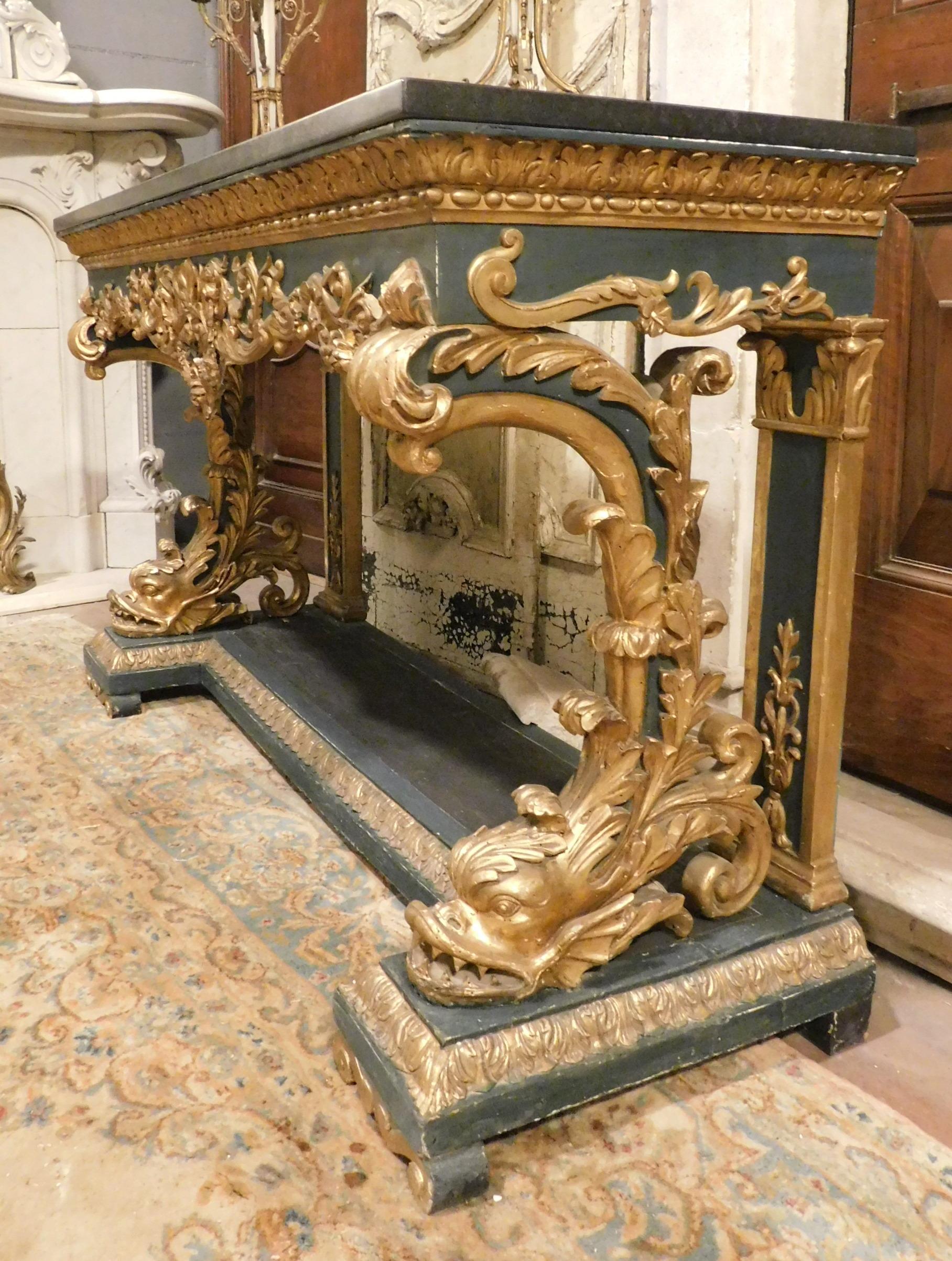 Belgian Black Marble Gilded and lacquered console in richly carved wood, black marble top, Italy For Sale