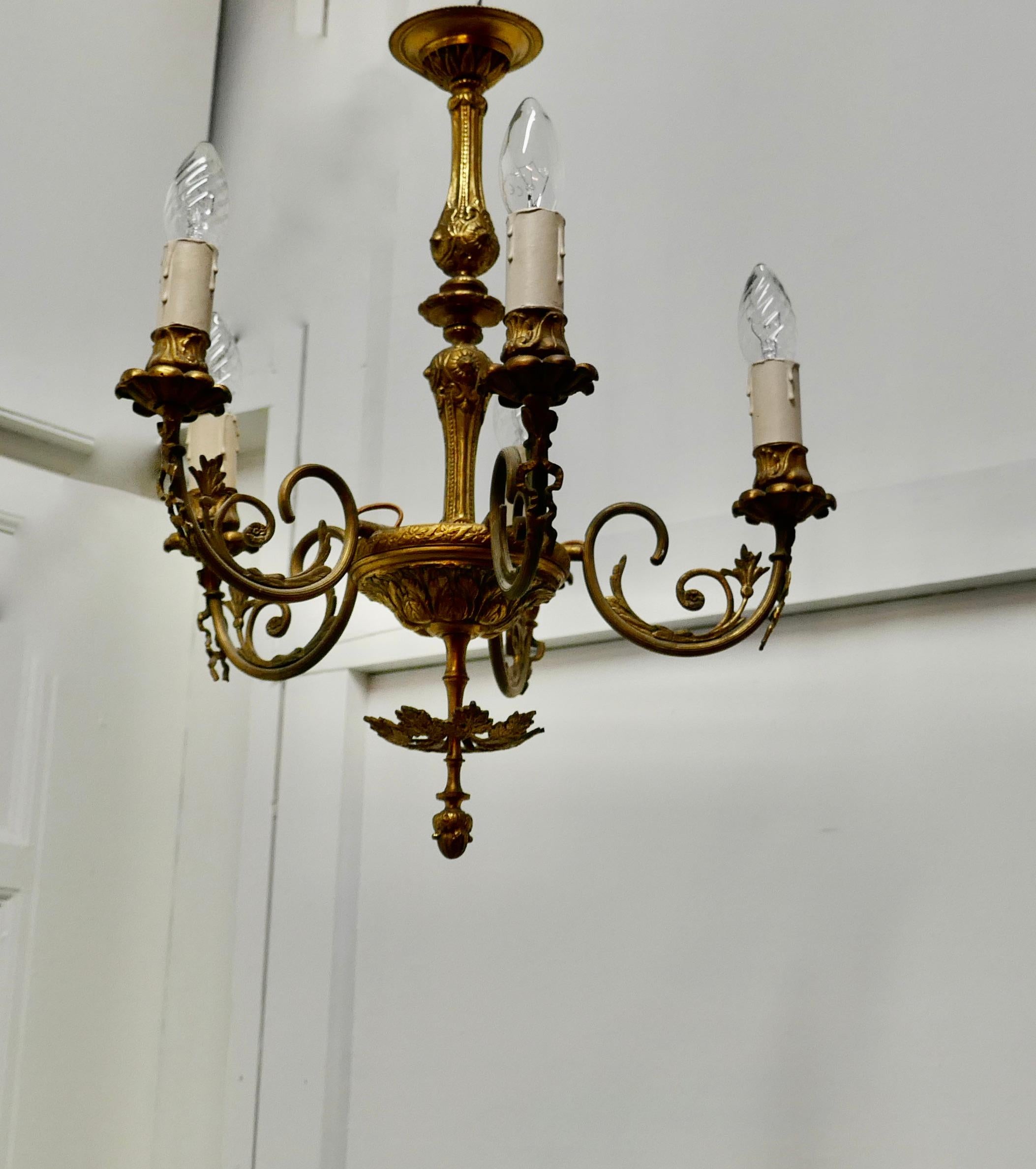 Gilded Brass 5 Branch Rococo Style Chandelier 

The chandelier has 5 branches, and is decorated in the Rocco fashion, very decorative brass work with acanthus leaves and curls
The chandelier is in working, and will need to be installed by an