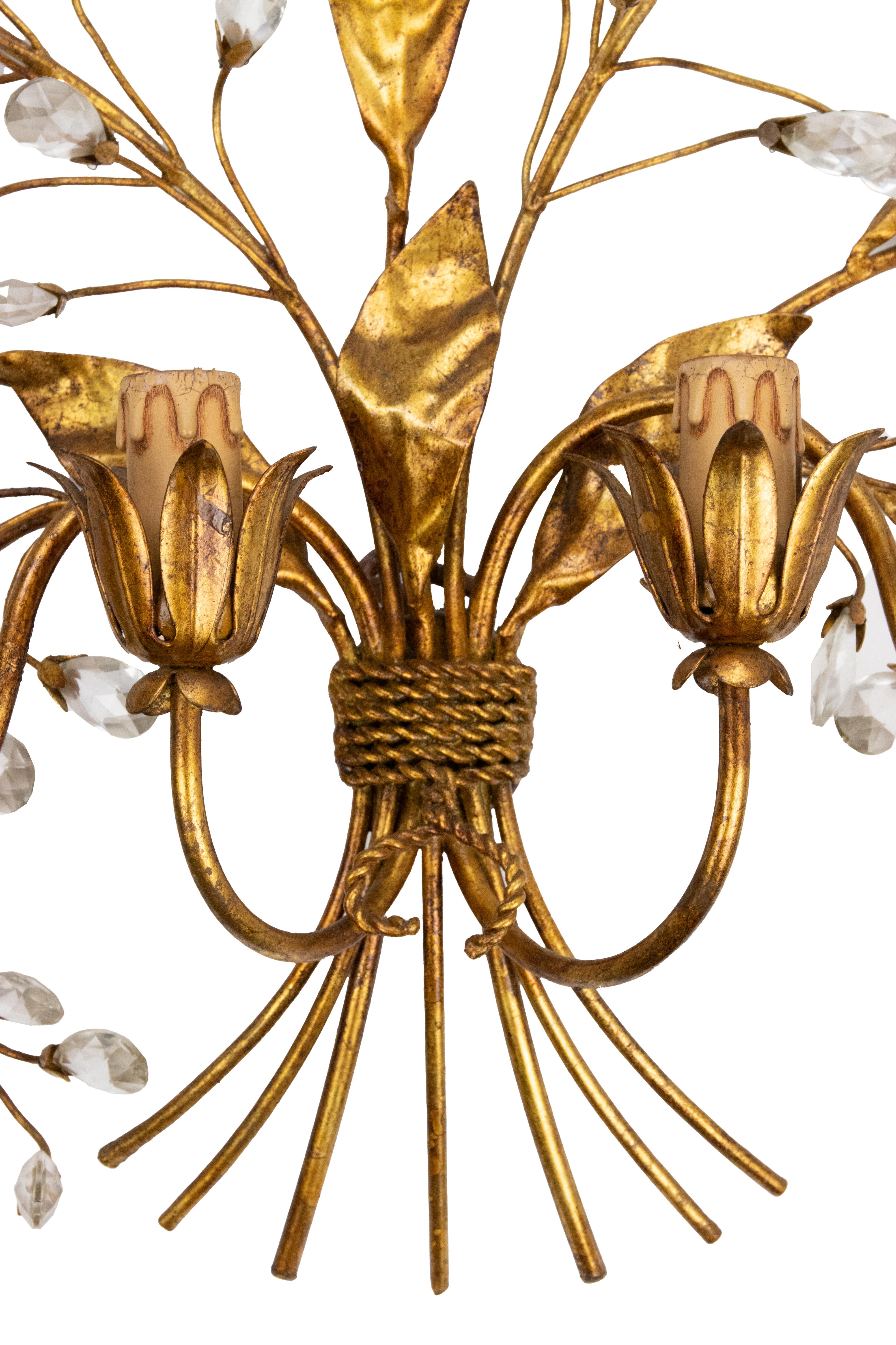 Gilded Brass Applique in the style of Hans Kogl, late 20th Century.

4 lights, with crystal drops in the shape of flowers.

98 X 90 CM.

Very good condition. 